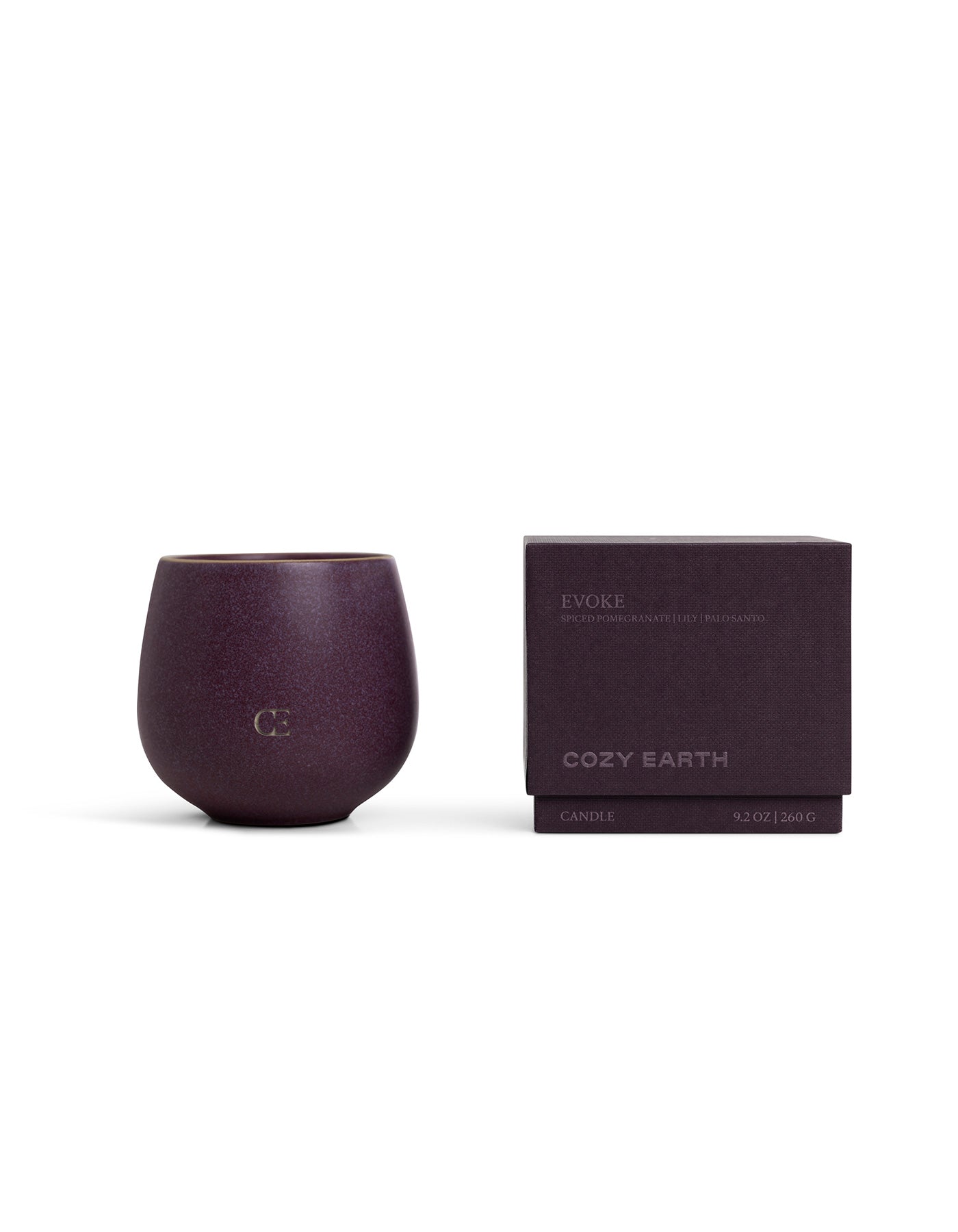 A deep purple Cozy Earth Candle EVOKE in a rounded cup with "CE" embossed on the front sits beside a matching purple box labeled "Evoke." Size: 9.2 oz (260 g).