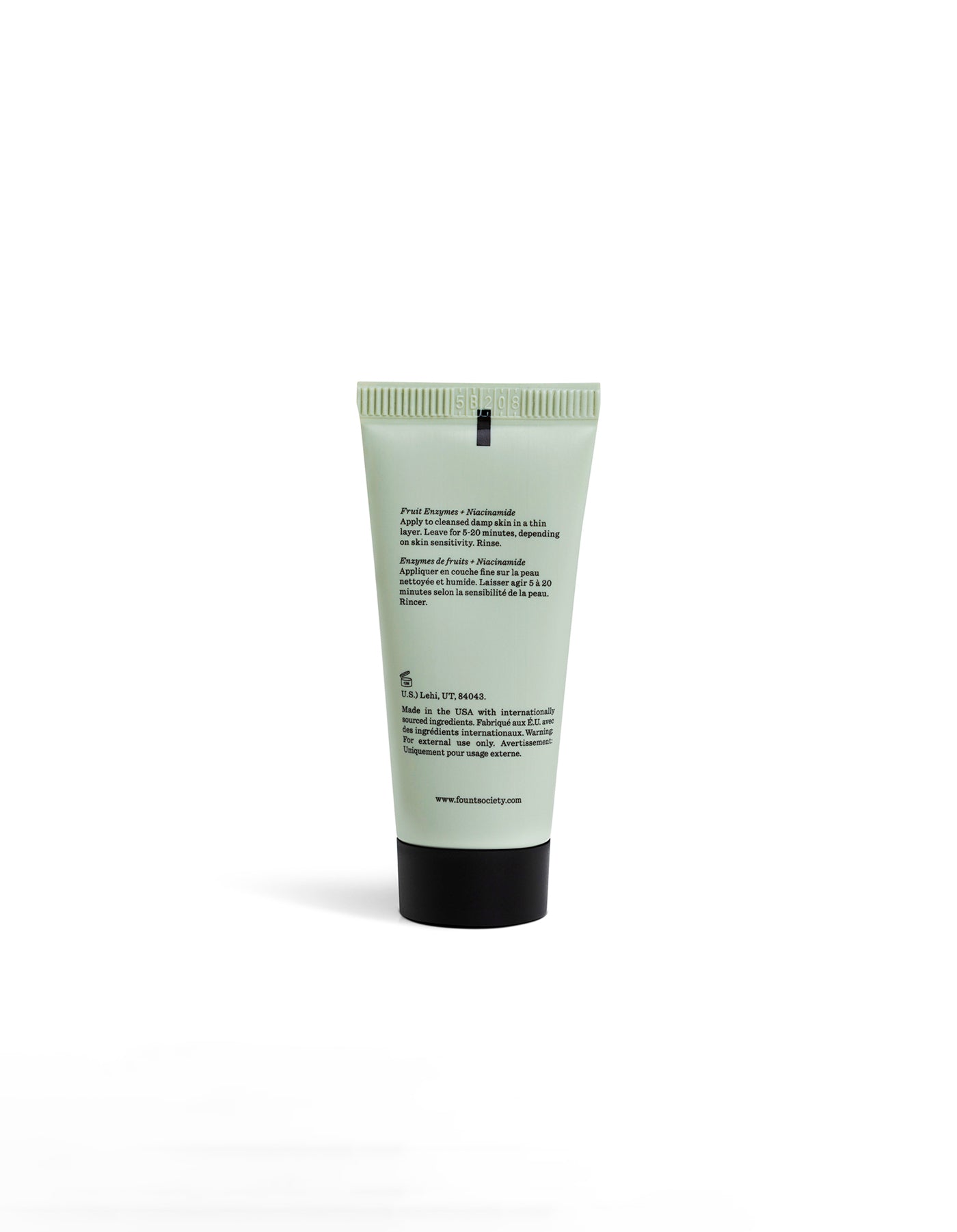 A light green tube of Cozy Earth's Enzyme Mask stands upright on a white background, with black text on the back label listing ingredients and instructions. The website and company details are displayed at the bottom.