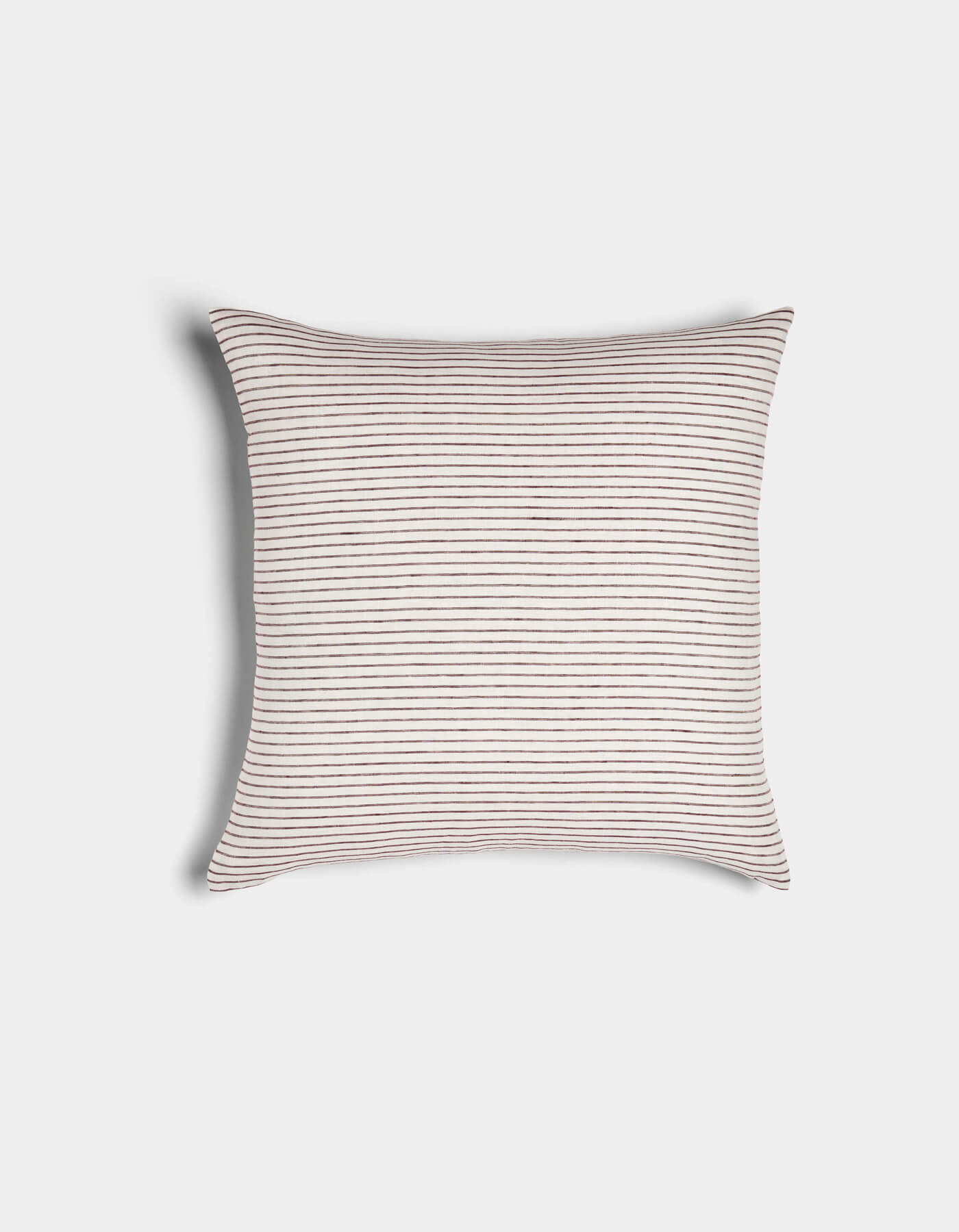 The Cozy Earth Striped Throw Pillow features thin, evenly spaced horizontal brown stripes on a white background. This soft, neatly plump accent piece is shown against a plain white backdrop.