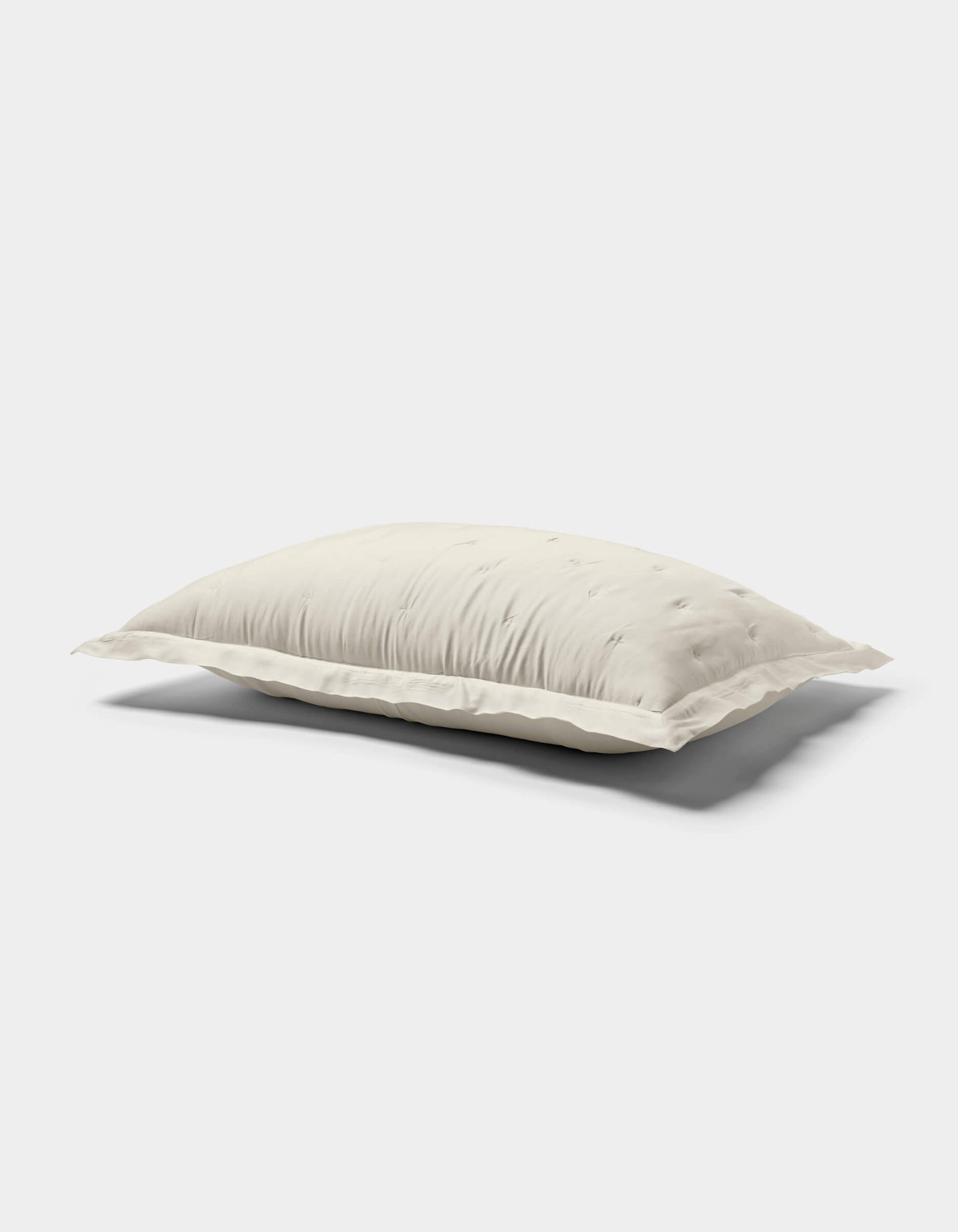 The Cozy Earth Bamboo Quilted Shams are shown against a plain white background, featuring a soft, white surface with subtle tufted details and gentle quilting.