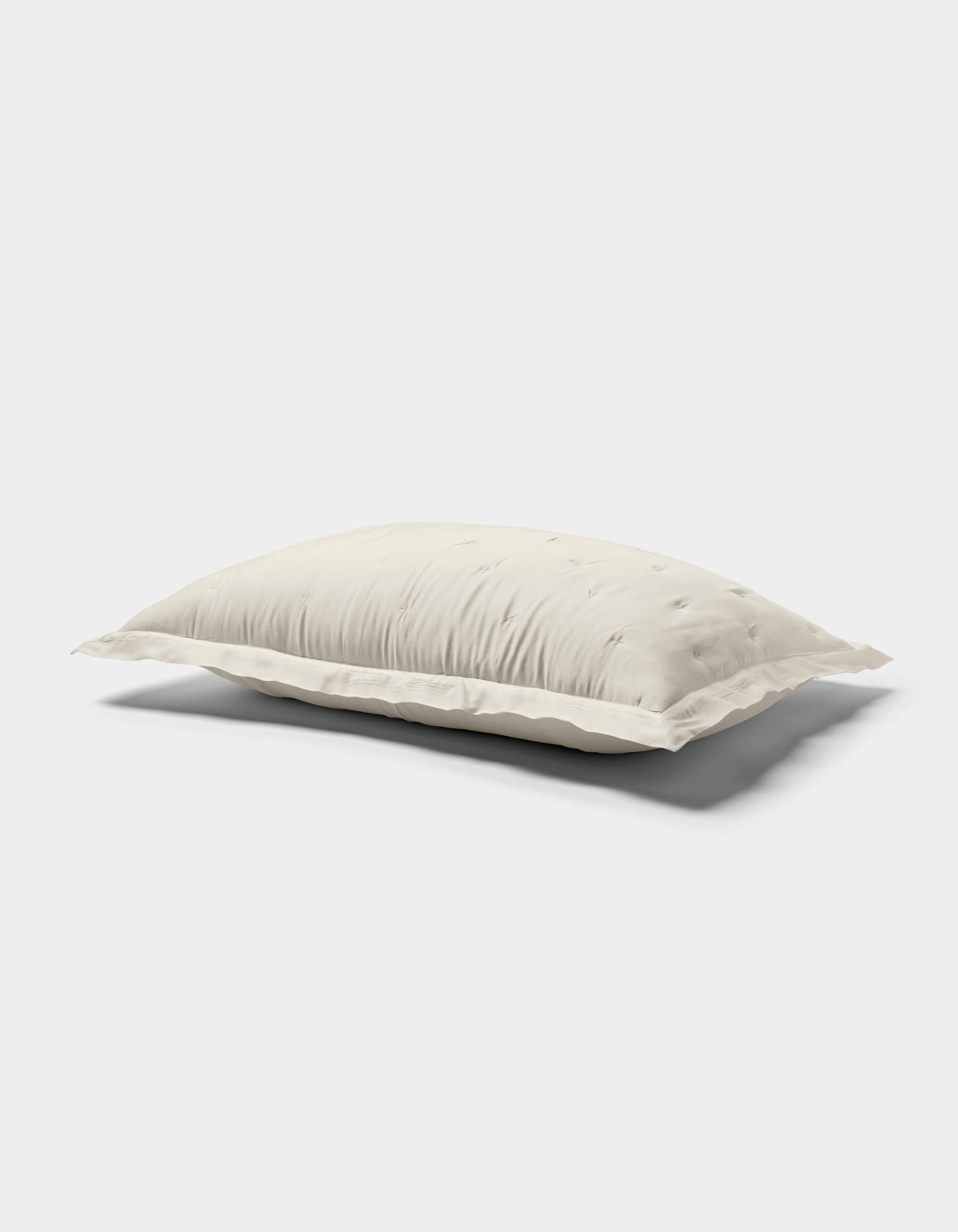 The Cozy Earth Bamboo Quilted Shams are shown against a plain white background, featuring a soft, white surface with subtle tufted details and gentle quilting.|Color:Oat