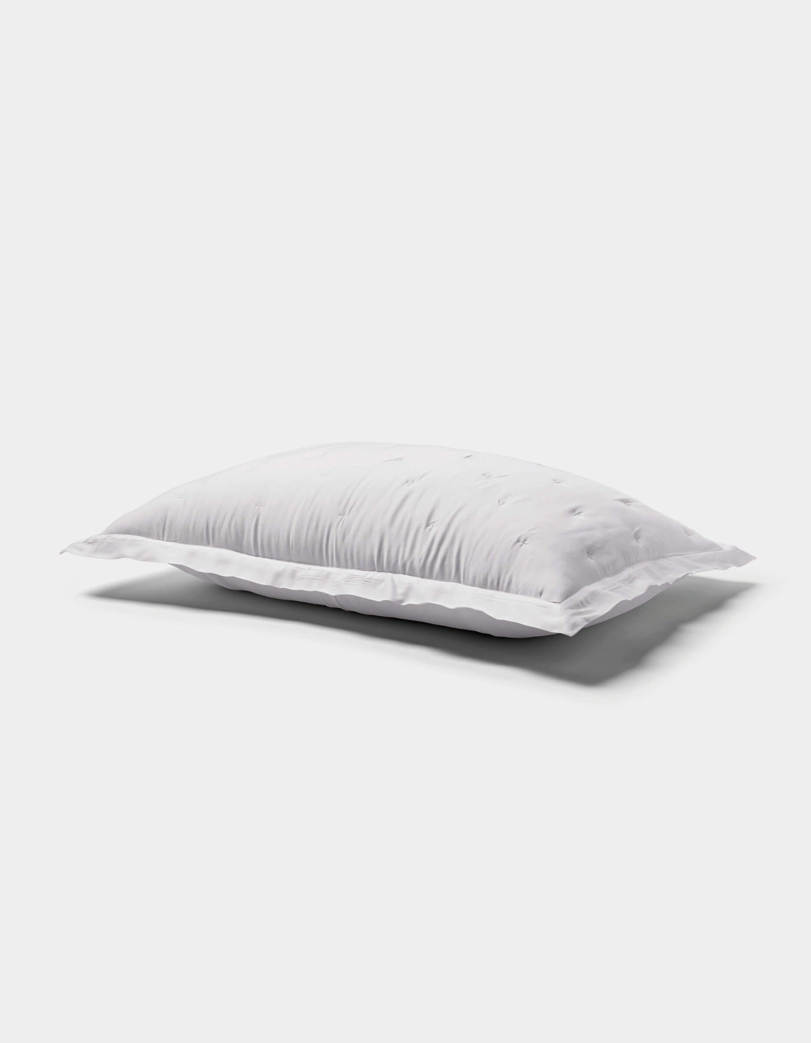 The Cozy Earth Bamboo Quilted Sham, with its smooth surface and lightly ruffled edges, rests on a plain white background and casts a gentle shadow below.