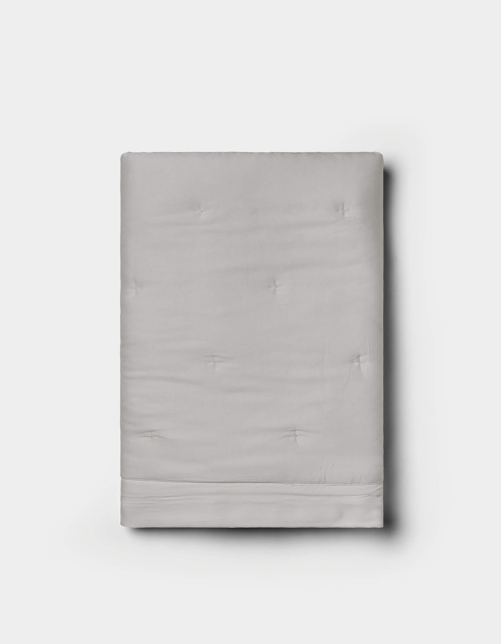 A neatly folded Cozy Earth Bamboo Quilted Sham in light gray with subtle tufted details, displayed against a plain white background.