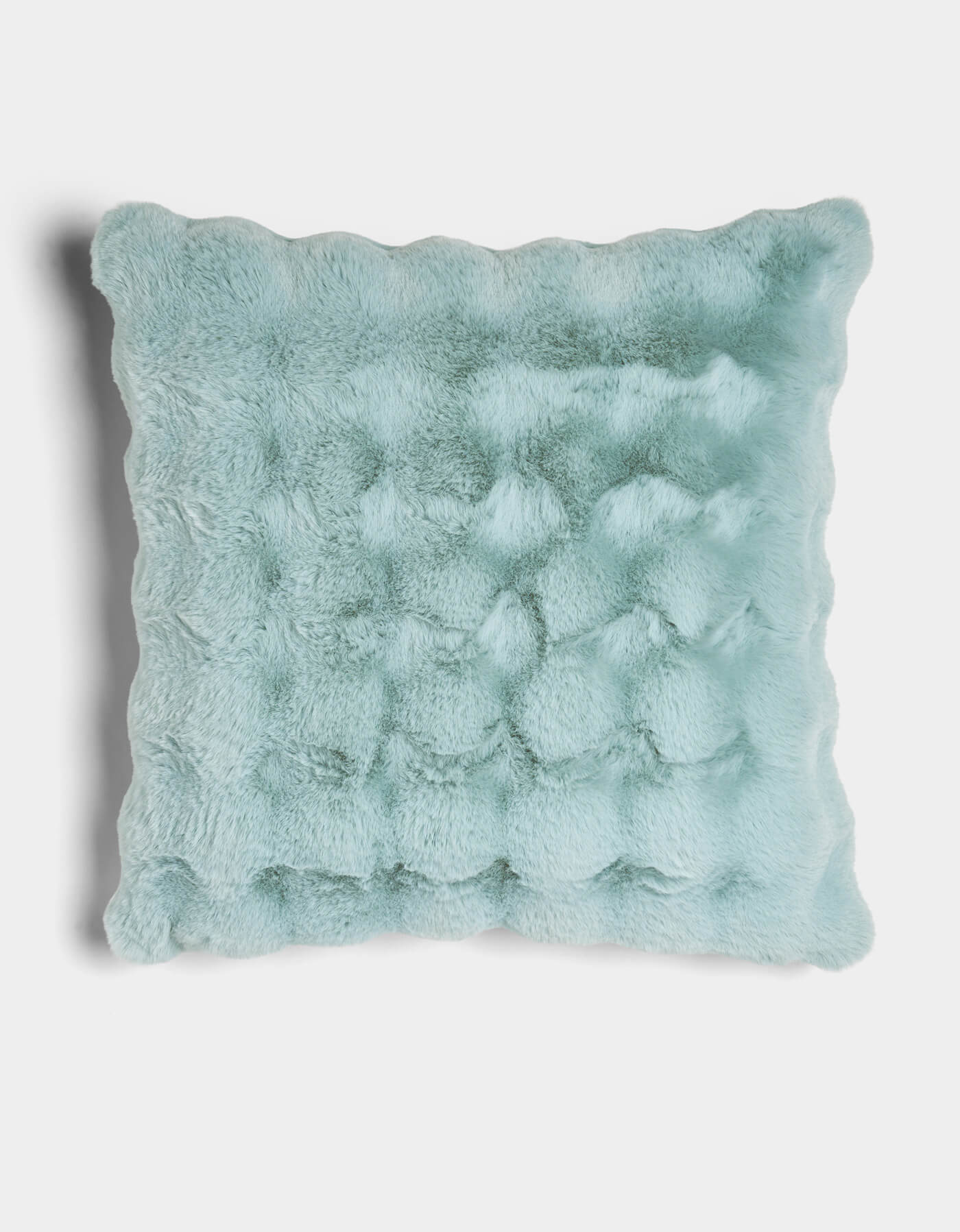 The Bubble Cuddle Pillow by Cozy Earth is a square, light blue faux fur pillow with a plush, textured surface and wavy scalloped edges, shown against a white background.|Color:Tide |Size:Euro