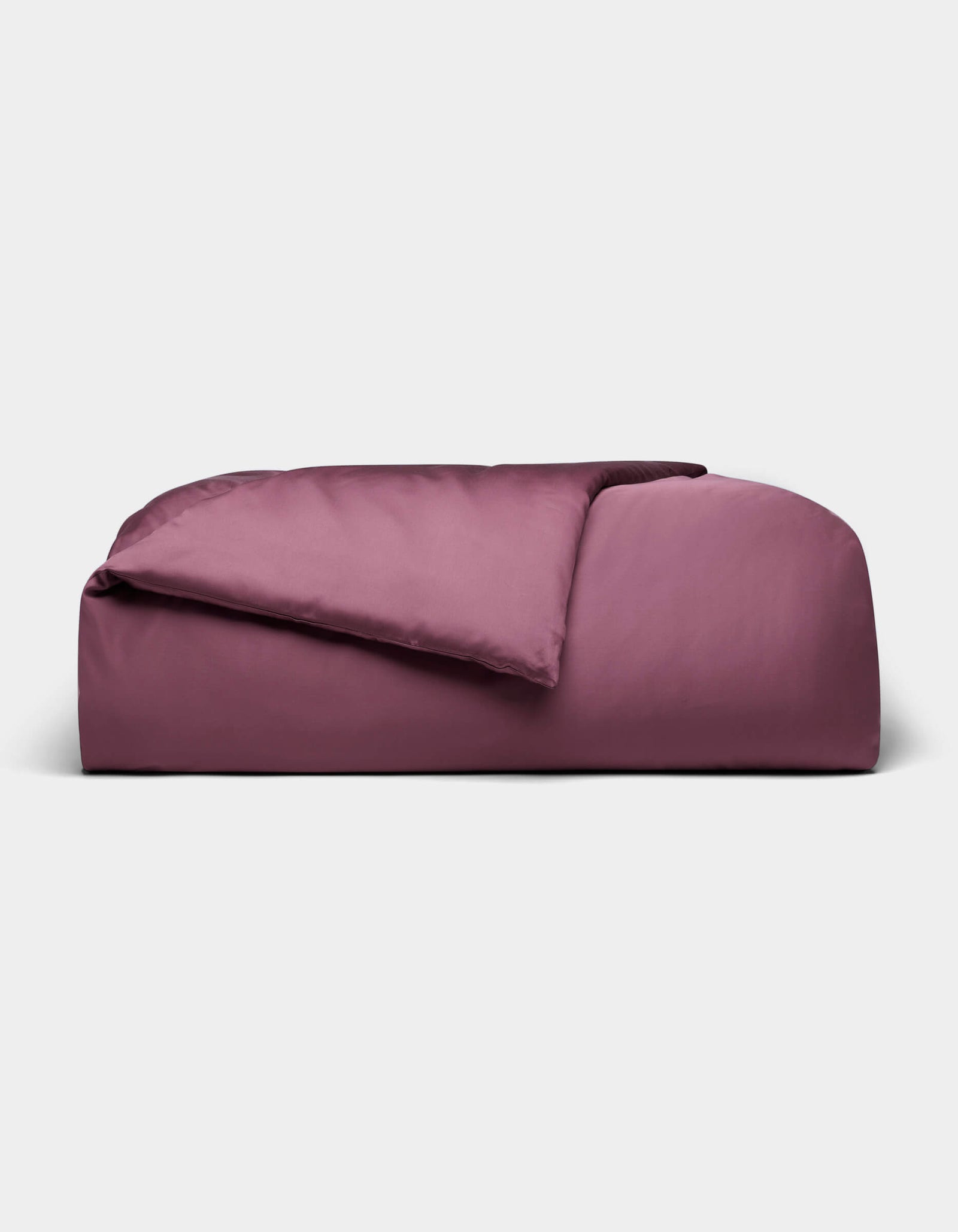 A large, rectangular Bamboo Duvet Cover from Cozy Earth in plum color with a soft, smooth surface, displayed against a plain light gray background.