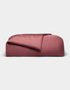 A rectangular, rose-colored Bamboo Duvet Cover from Cozy Earth with a soft, smooth texture and a gentle top fold, displayed against a plain light gray background.|Color:Mulberry