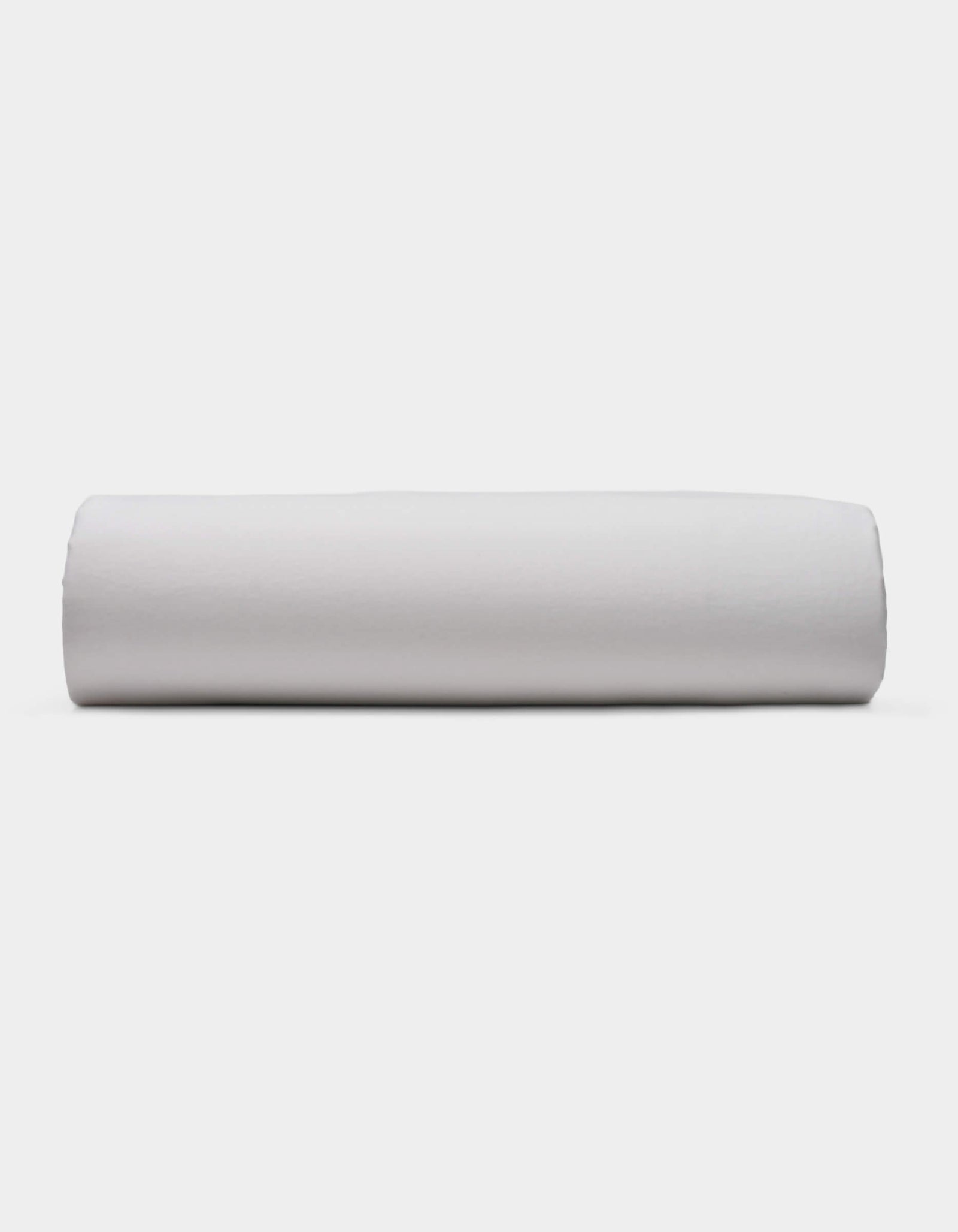 A Soft-Wash Cotton Fitted Sheet by Cozy Earth is displayed lying flat on a light surface with a neutral background.