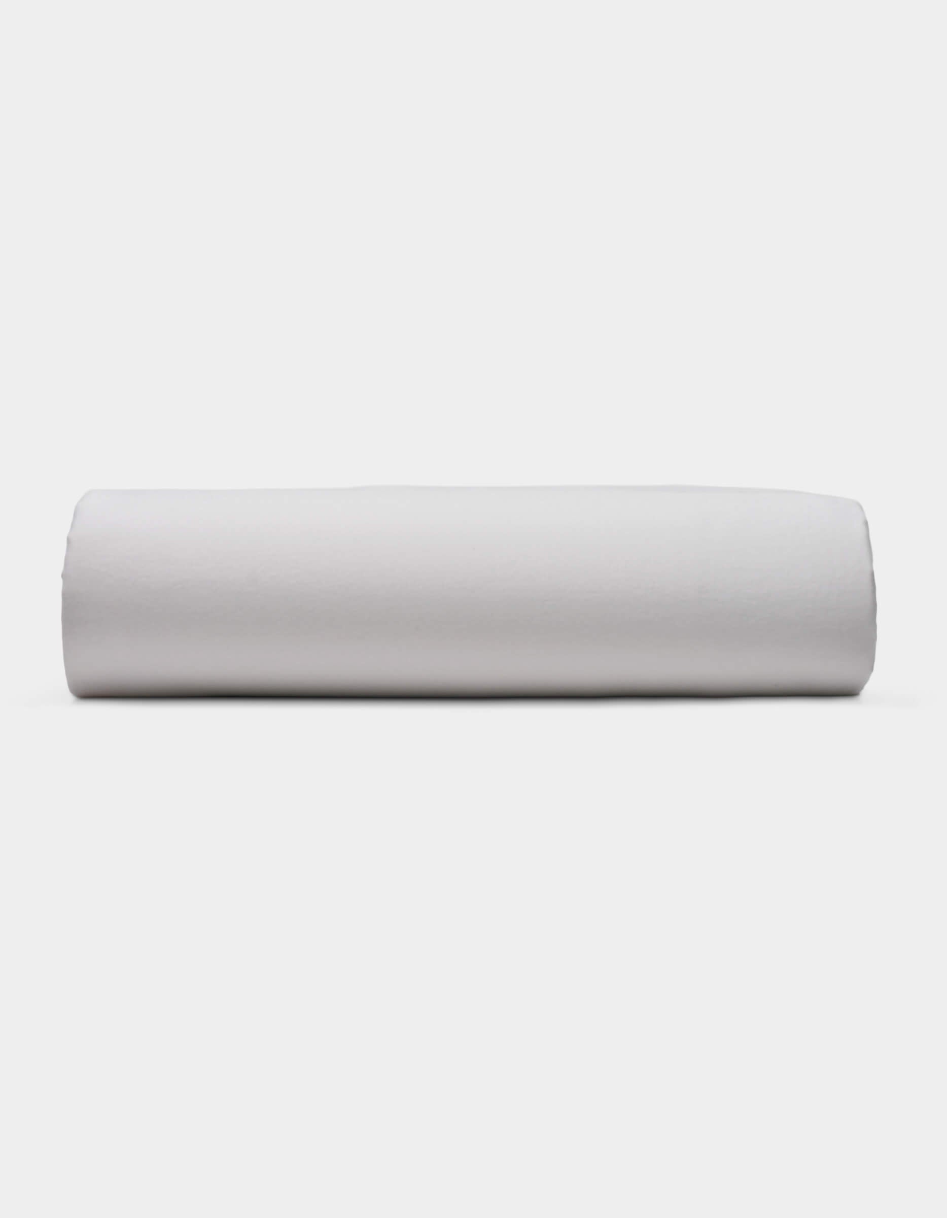 A Soft-Wash Cotton Fitted Sheet by Cozy Earth is displayed lying flat on a light surface with a neutral background.|Color:Dew