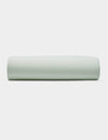 A Soft-Wash Cotton Fitted Sheet by Cozy Earth is displayed neatly folded against a plain white background.|Color:Laurel