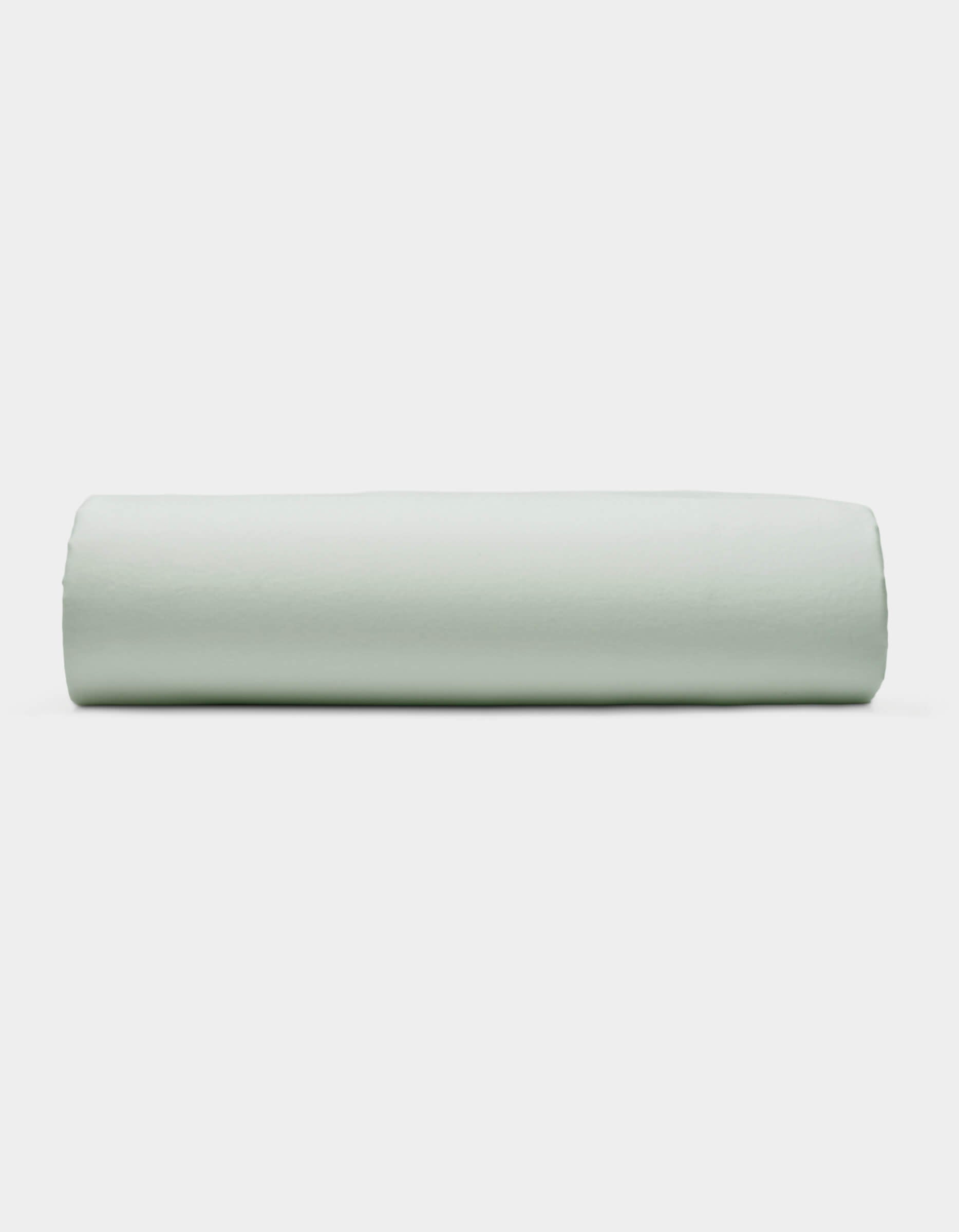 A Soft-Wash Cotton Fitted Sheet by Cozy Earth is displayed neatly folded against a plain white background.|Color:Laurel