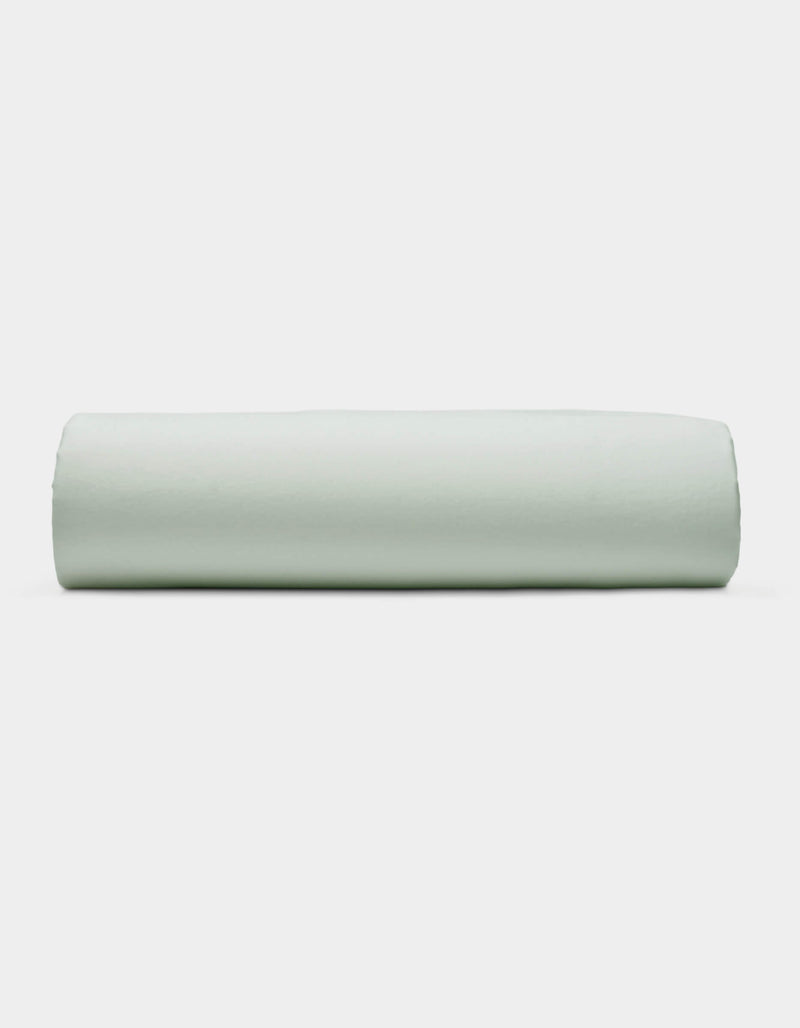 A Soft-Wash Cotton Fitted Sheet by Cozy Earth is displayed neatly folded against a plain white background.