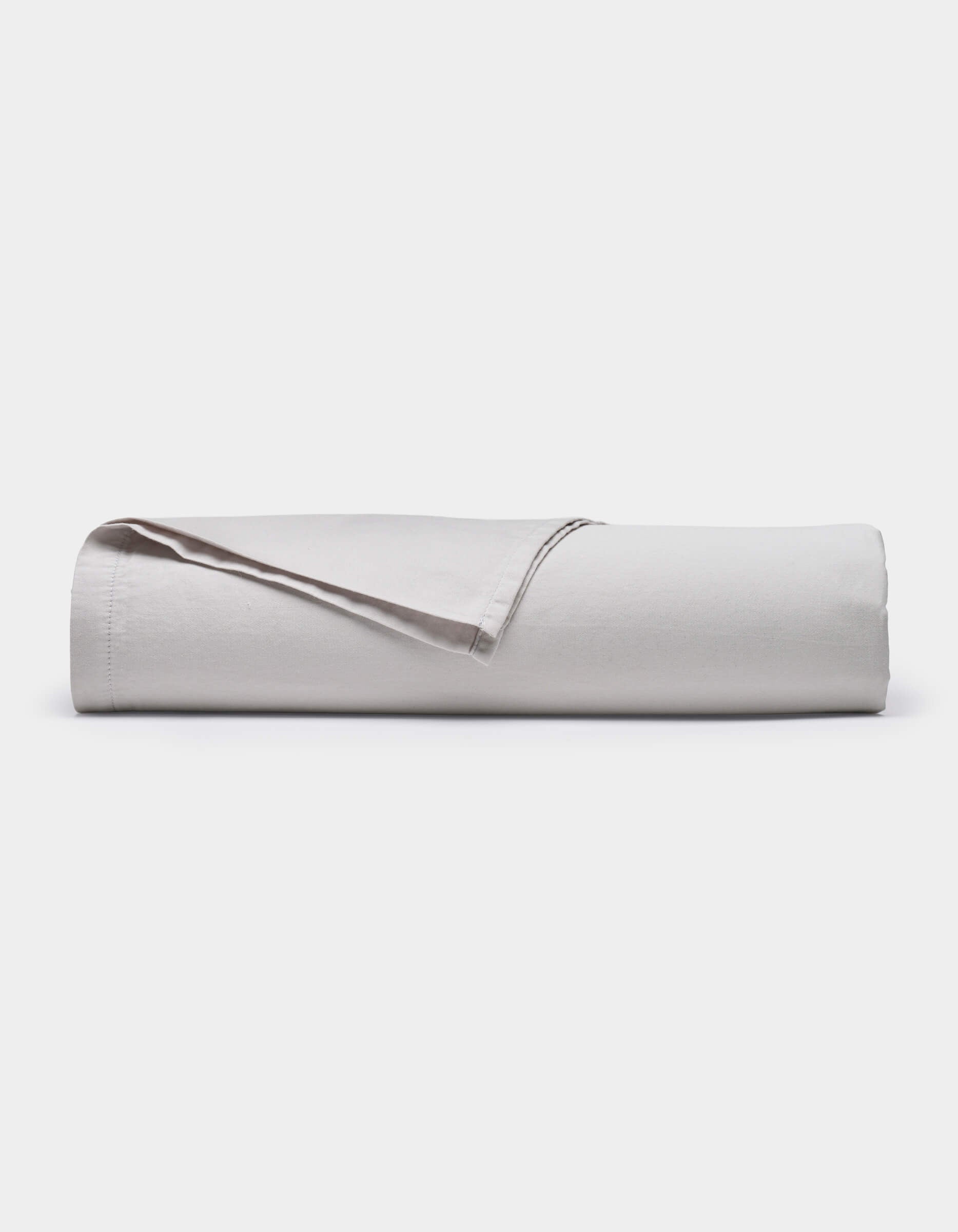 The Cozy Earth Soft-Wash Cotton Flat Sheet, shown neatly rolled with one edge lifted, is displayed against a plain white background.|Color:Dew