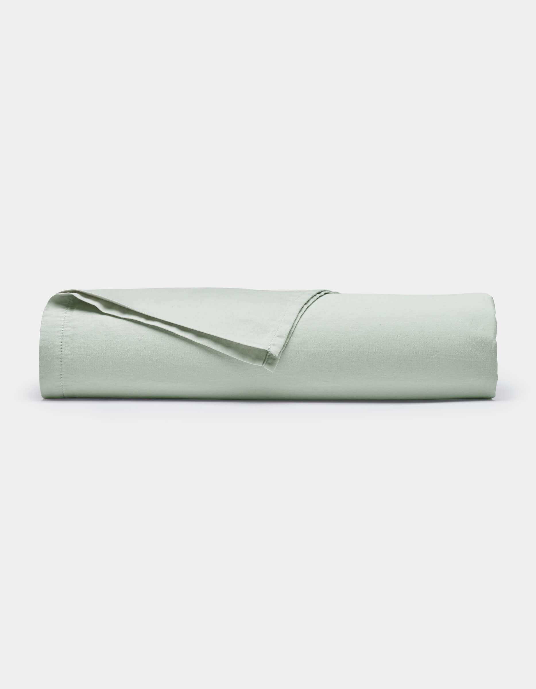 The Cozy Earth Soft-Wash Cotton Flat Sheet in light green is neatly folded and displayed against a plain white background.|Color:Laurel