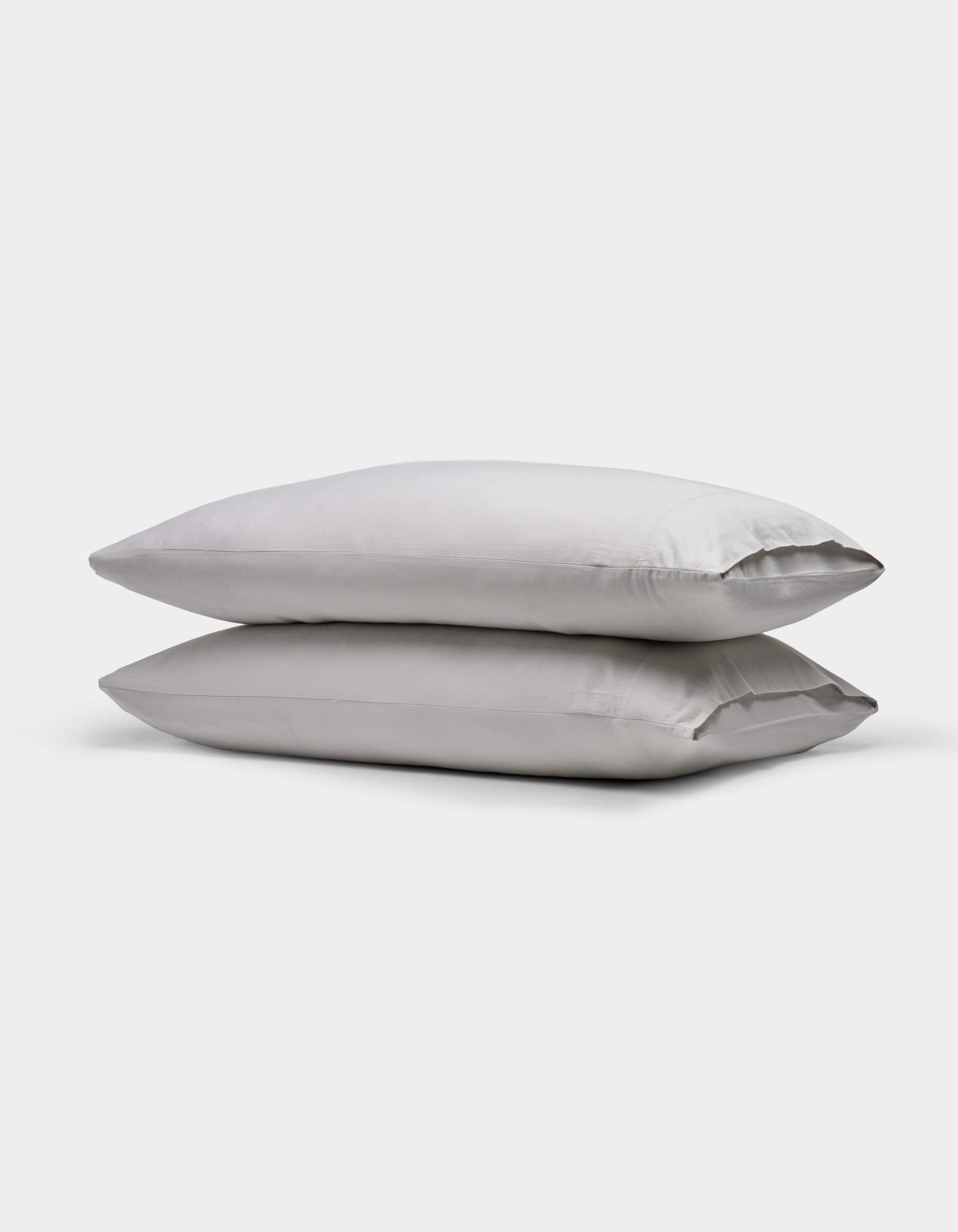 Two stacked, rectangular Soft-Wash Cotton Pillowcases by Cozy Earth in light gray are shown on a plain white background.