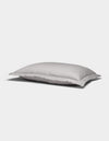 A Soft-Wash Cotton Quilted Sham by Cozy Earth, white and rectangular with a smooth surface, rests on a plain light gray background.|Color:Dew