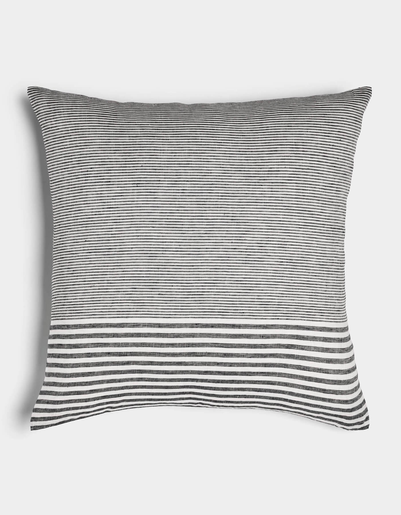 The Cozy Earth Striped Throw Pillow features thin black and white horizontal stripes with a bold, wider band at the bottom on a plain white background.