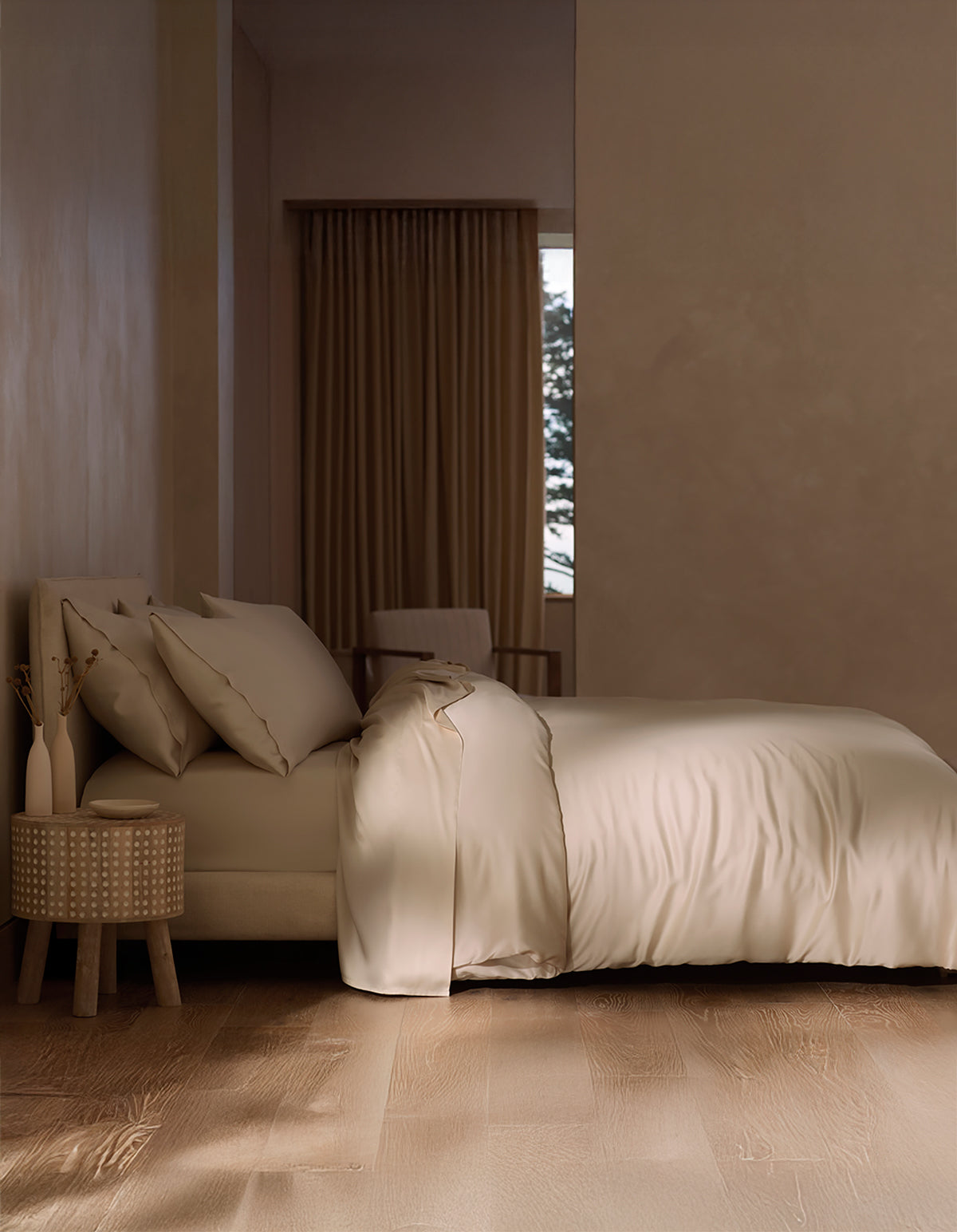 A neatly made bed features the Cozy Earth Bamboo Duvet Cover in beige beside a textured wooden nightstand with two vases. Large curtained windows reveal a winter scene.|Color:Driftwood