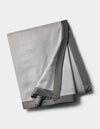 The Cozy Earth Bamboo Blanket is a folded light gray fleece with a smooth, dark gray satin border, shown on a plain white background.|Color:Dove Grey/Charcoal