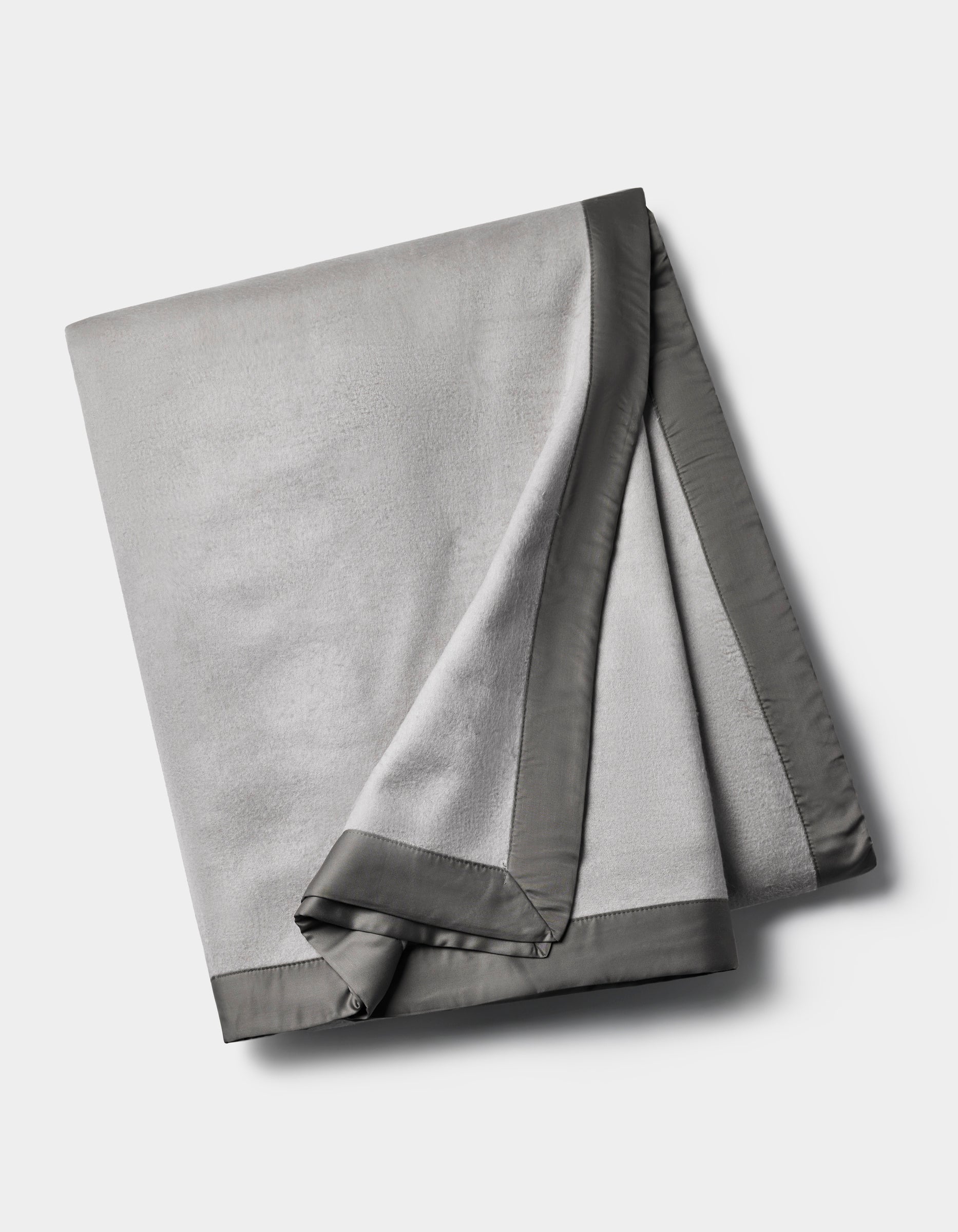 The Cozy Earth Bamboo Blanket is a folded light gray fleece with a smooth, dark gray satin border, shown on a plain white background.|Color:Dove Grey/Charcoal
