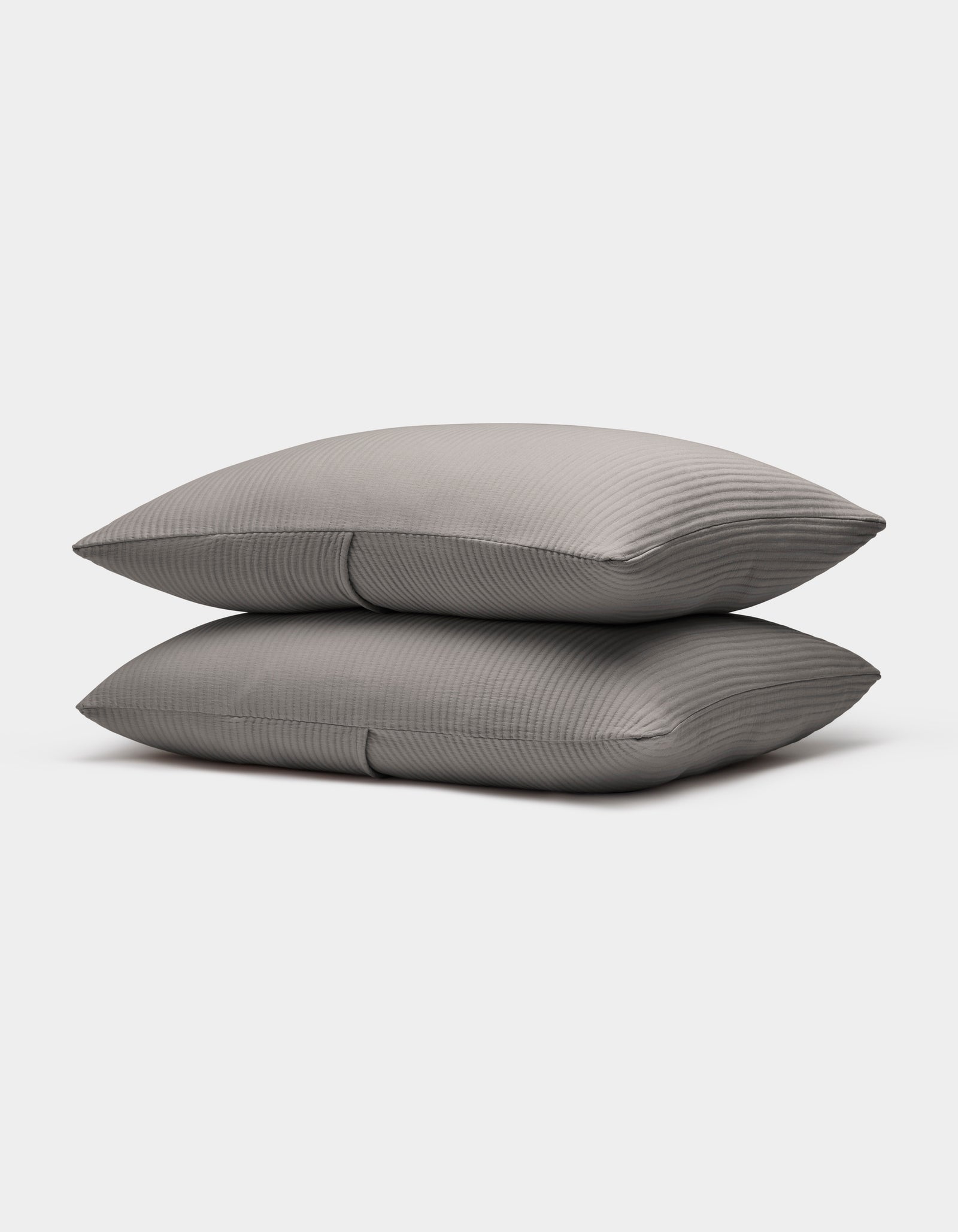 Two neatly stacked Bamboo Coverlet Shams by Cozy Earth in gray with stripes, displayed on a plain white background.