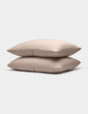 Two Bamboo Coverlet Shams by Cozy Earth, in light beige with a subtle ribbed texture, are stacked neatly against a plain white background.|Color:Driftwood