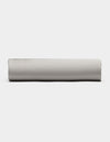 A Bamboo Fitted Sheet by Cozy Earth in light gray is displayed from the side against a plain white background.|Color:Light Grey