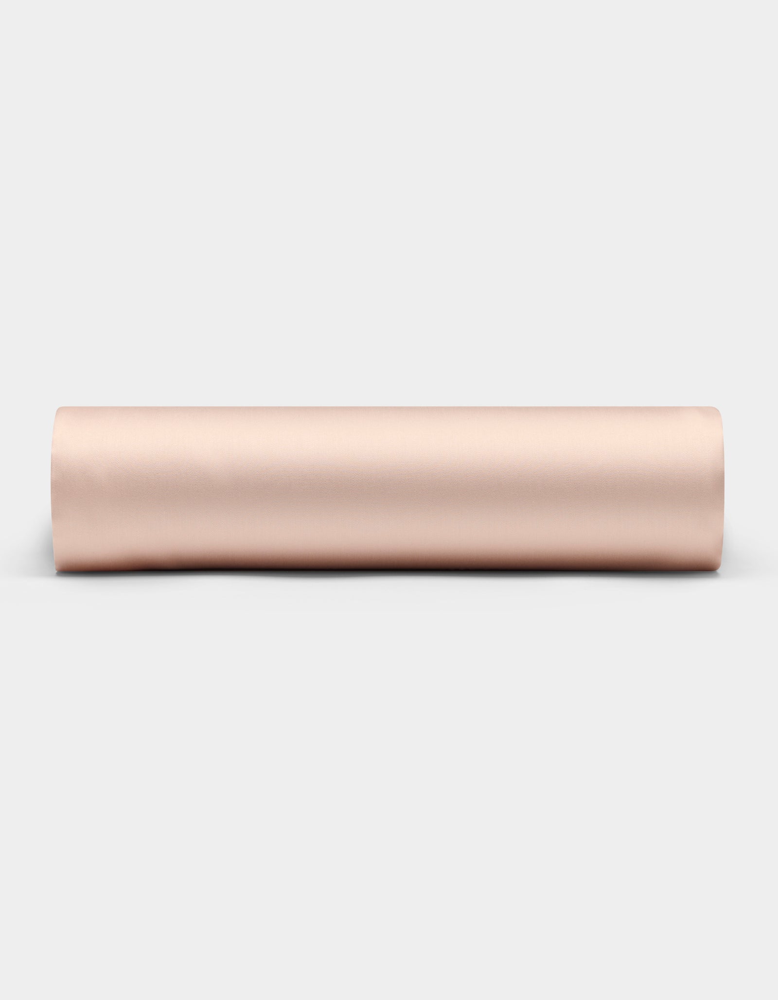 A Cozy Earth Bamboo Fitted Sheet in a light beige shade is shown rolled up on a plain white background, viewed from the side.