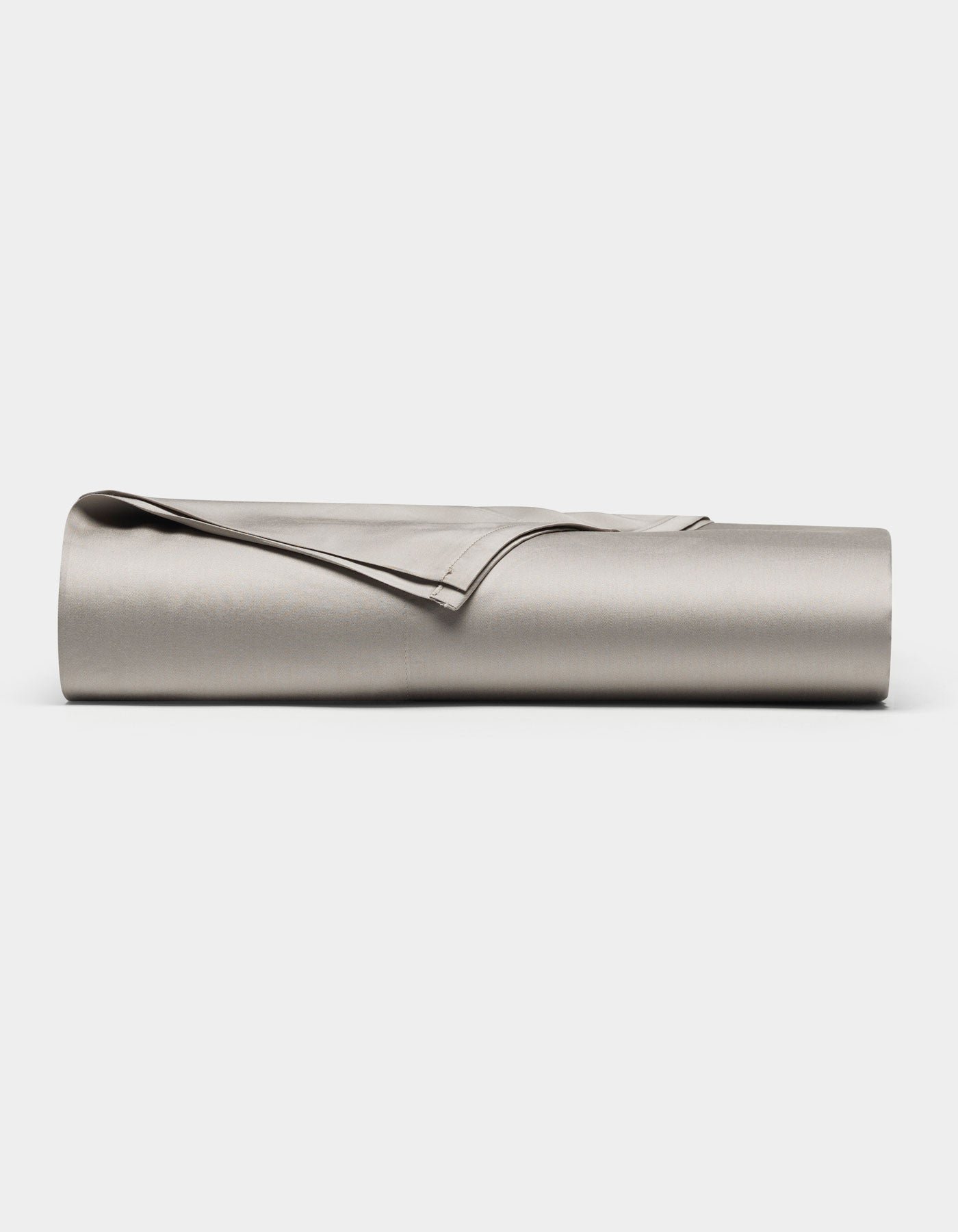 The Cozy Earth Bamboo Flat Sheet, in light gray, is neatly rolled and displayed on a plain white background.