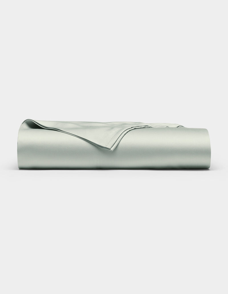 The Cozy Earth Bamboo Flat Sheet, in a light gray shade, is shown neatly folded with smooth edges on a plain white background.