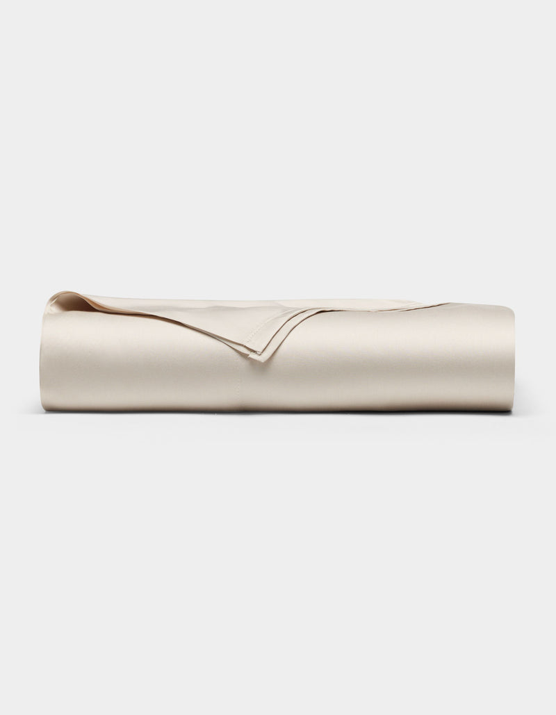 A neatly folded Cozy Earth Bamboo Flat Sheet in light beige or cream, displayed against a plain white background.