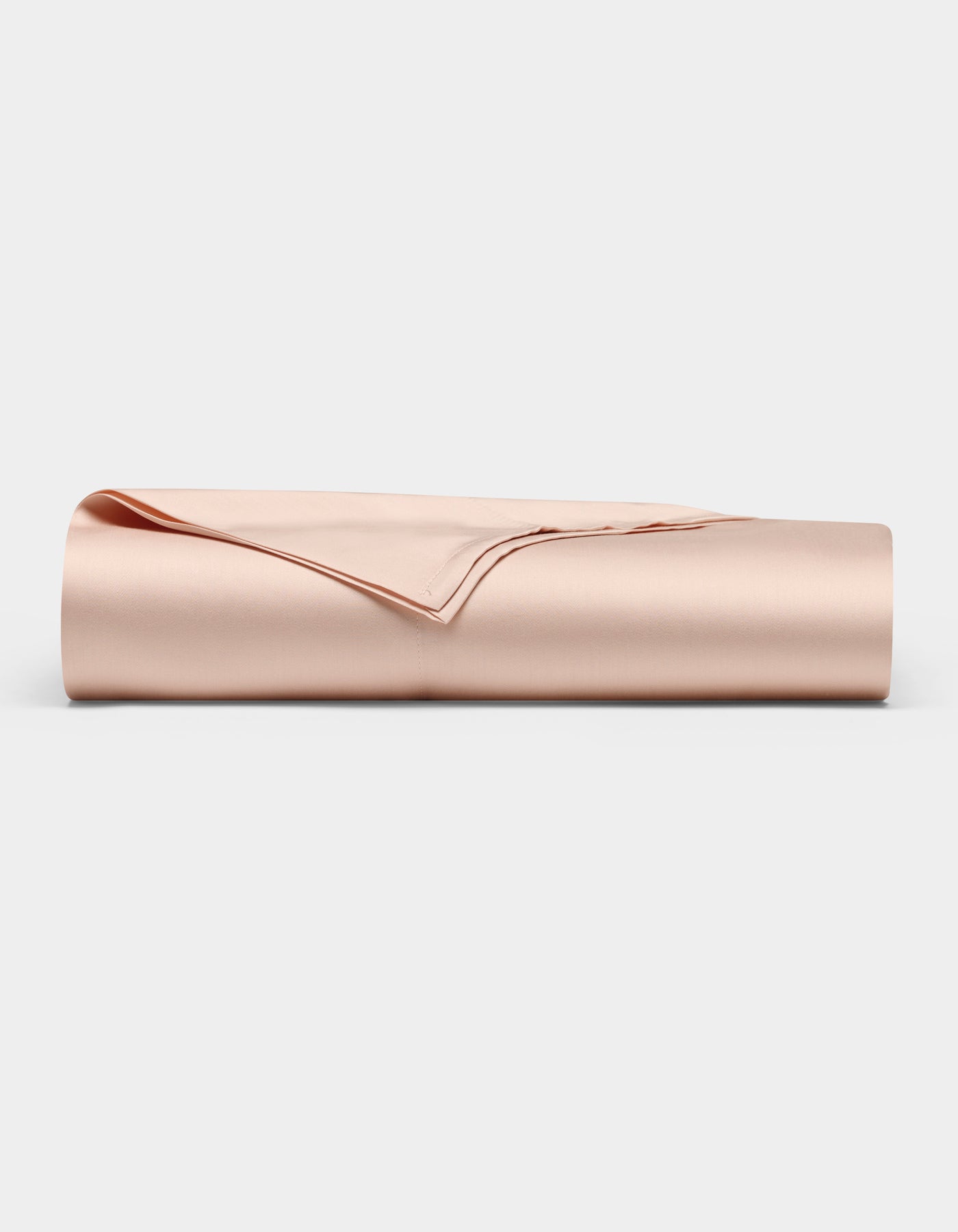 The Bamboo Flat Sheet by Cozy Earth, shown neatly folded in a light beige satin finish, is displayed against a plain white background.