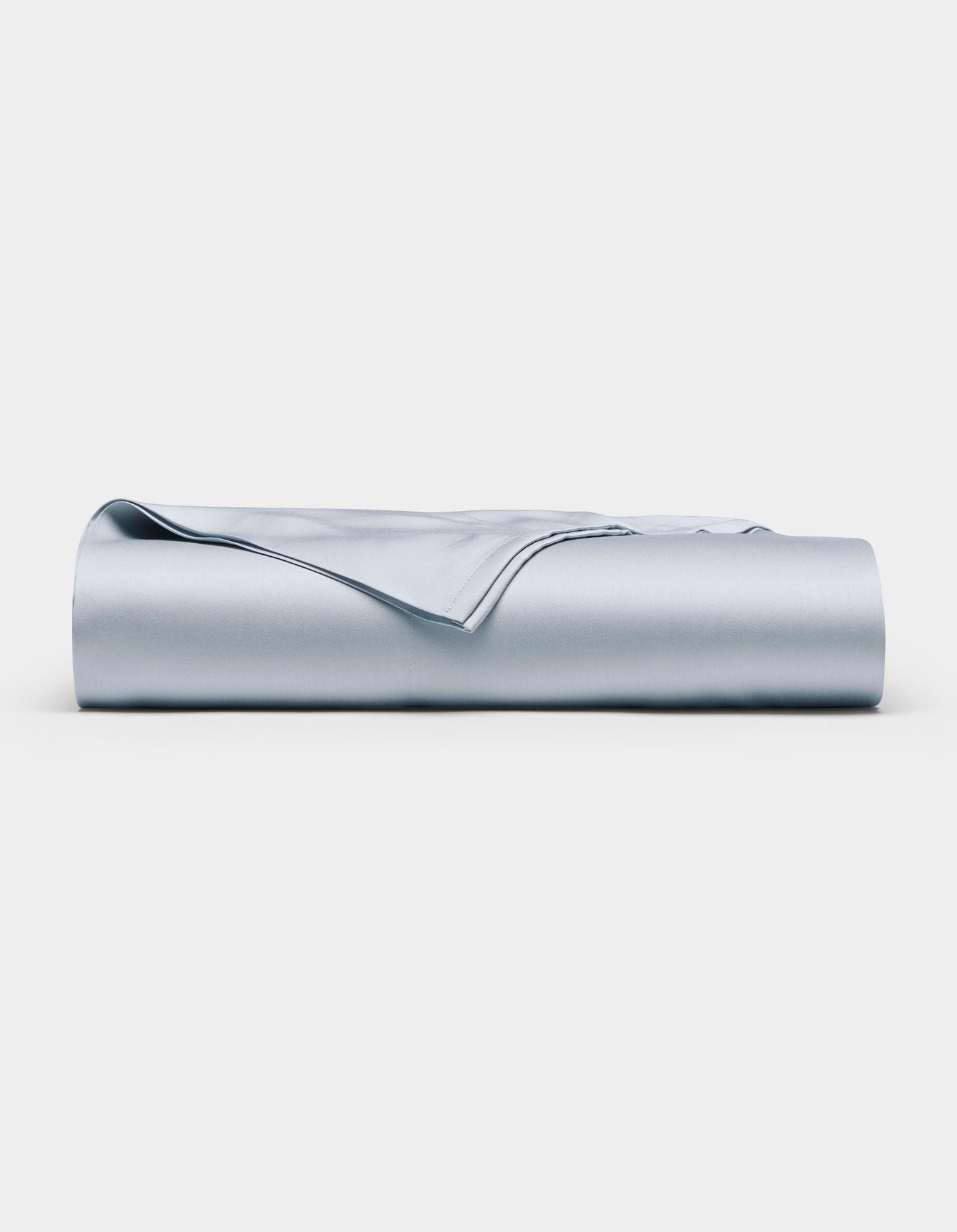 The Cozy Earth Bamboo Flat Sheet in light blue is neatly folded and displayed against a plain white background.