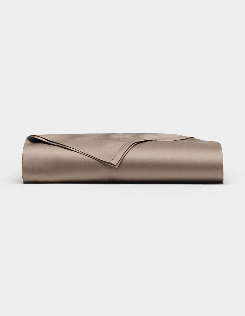A neatly folded Bamboo Flat Sheet by Cozy Earth in taupe is displayed on a plain white background.