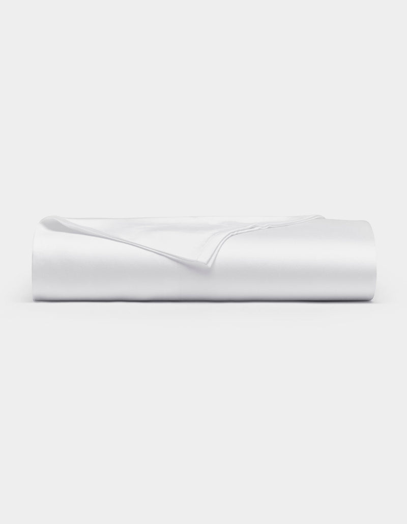 A neatly folded Cozy Earth Bamboo Flat Sheet in white rests on a flat surface against a plain white background.