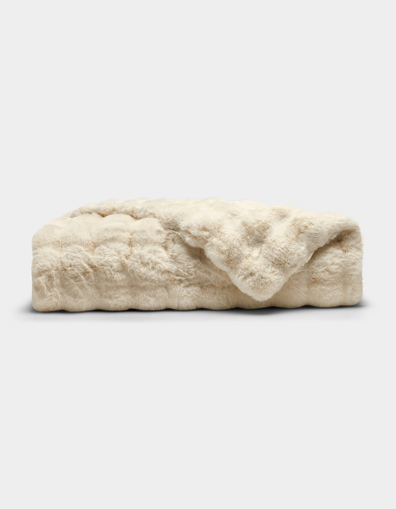 The Cozy Earth Bubble Cuddle Blanket is a folded, cream-colored faux fur throw with a soft, plush texture, shown against a plain white background.