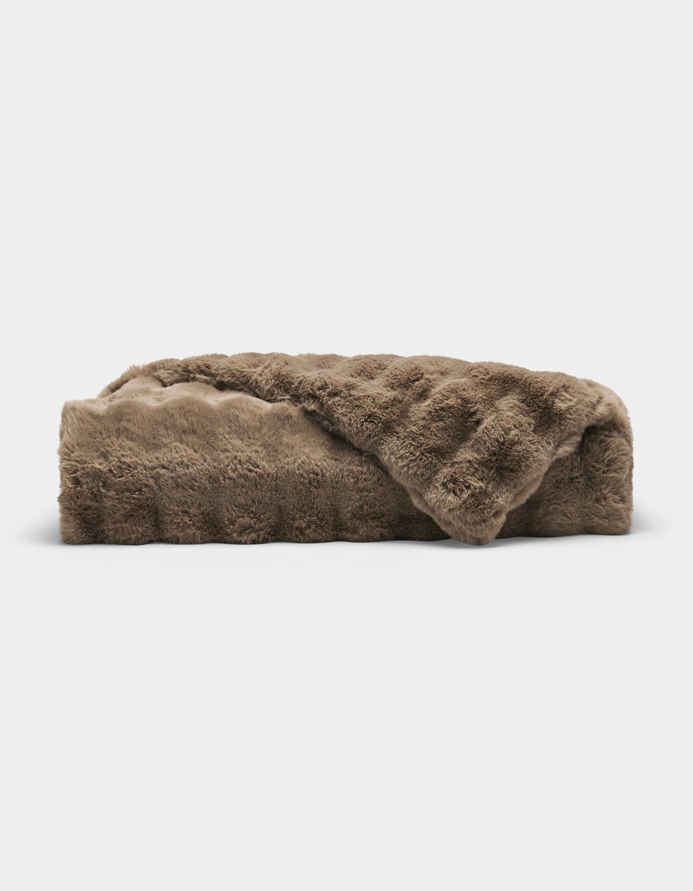 The Bubble Cuddle Blanket by Cozy Earth, made of soft brown faux fur, is folded neatly against a plain white background.