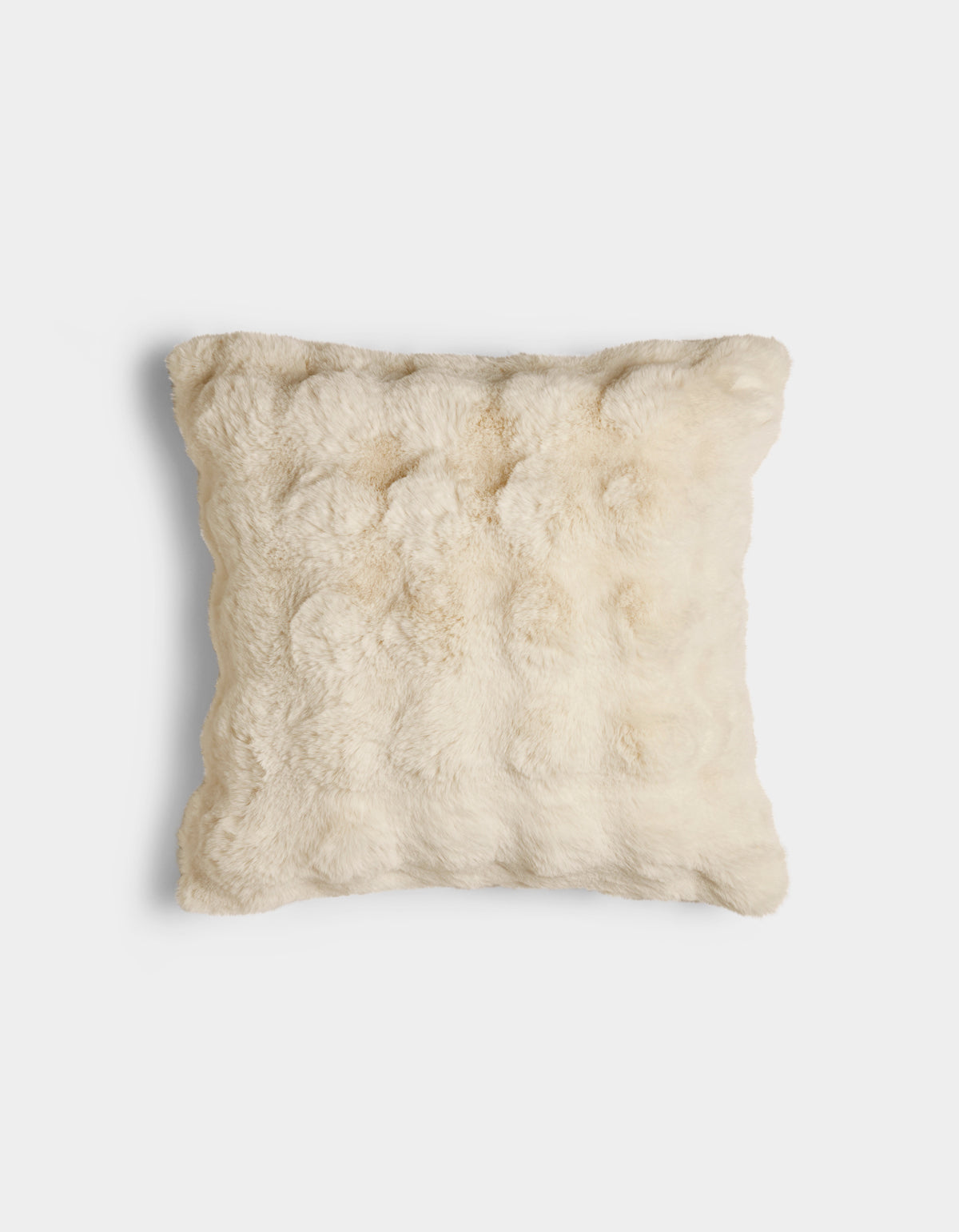 The Bubble Cuddle Pillow by Cozy Earth is a square, cream-colored pillow with a soft, fur-like texture, displayed against a plain white background.