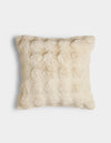 The Bubble Cuddle Pillow by Cozy Earth is a square, cream-colored pillow with a soft, fur-like texture, displayed against a plain white background.|Color:Creme |Size:24" x 24"