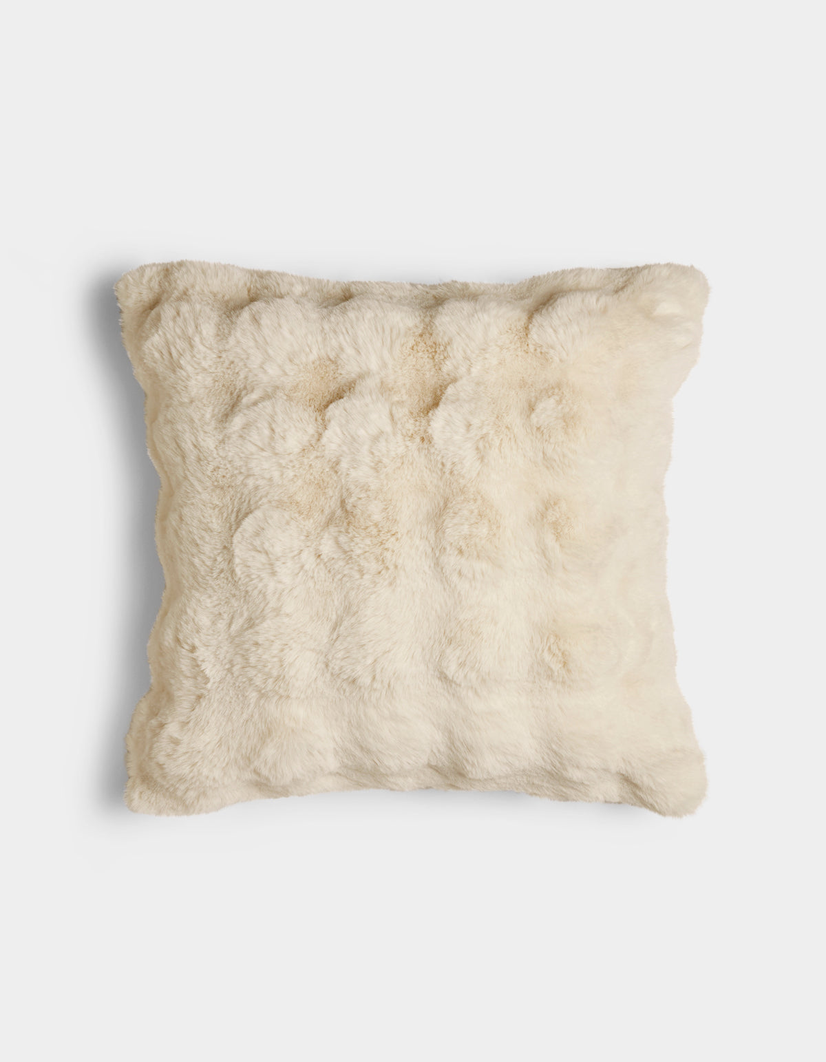 The Bubble Cuddle Pillow by Cozy Earth is a square, cream-colored pillow with a soft, fur-like texture, displayed against a plain white background.