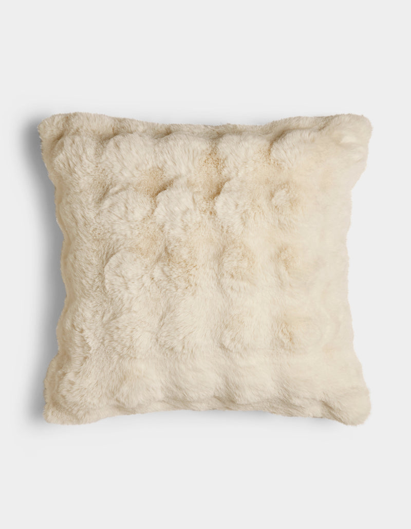 The Bubble Cuddle Pillow by Cozy Earth is a square, cream-colored pillow with a soft, fur-like texture, displayed against a plain white background.