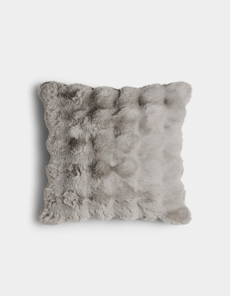 The Bubble Cuddle Pillow by Cozy Earth is a square, light gray faux fur pillow with a soft, fluffy texture, displayed against a plain white background.