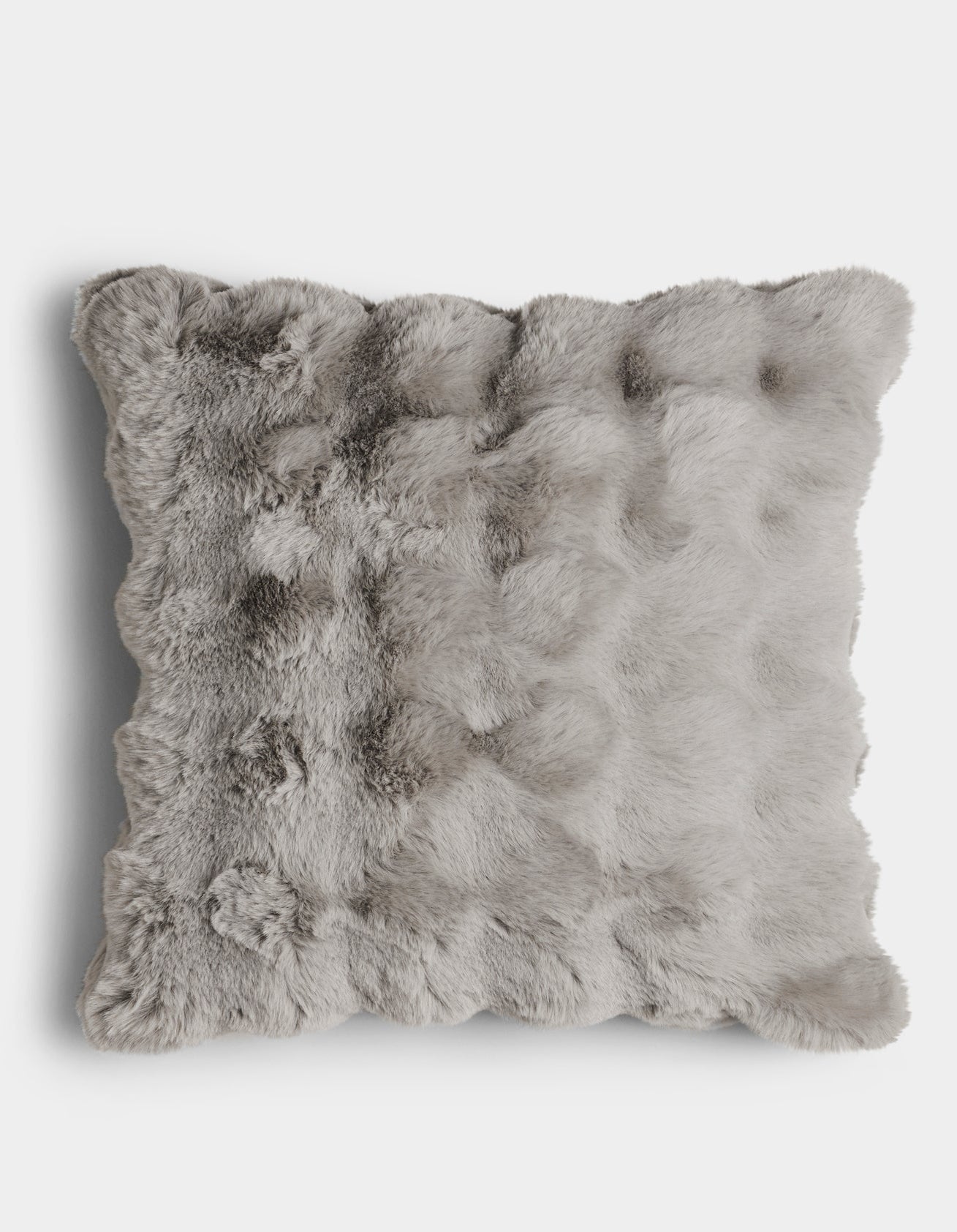 The Bubble Cuddle Pillow by Cozy Earth is a square, light gray faux fur cushion with a fluffy, textured surface, shown from above on a plain white background.
