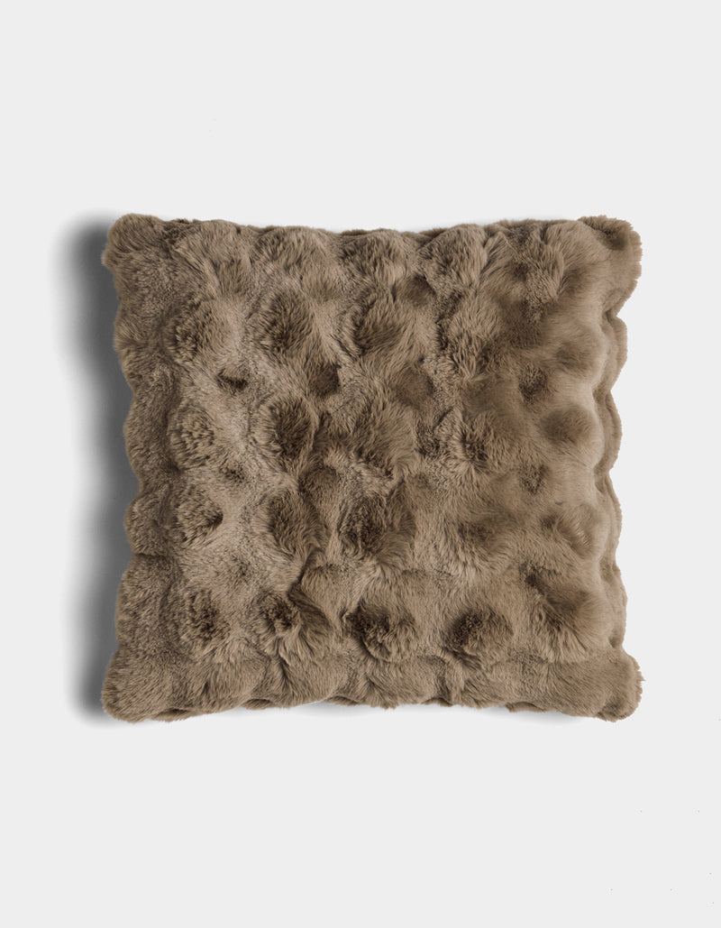 The Bubble Cuddle Pillow by Cozy Earth is a square, brown faux fur pillow with a textured, tufted surface, shown against a white background.