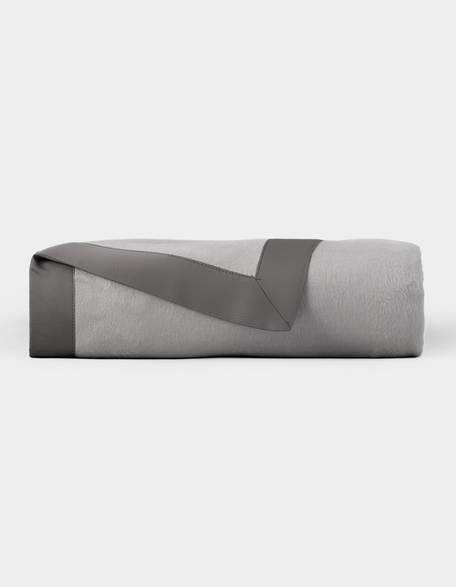 The Cozy Earth Bamboo Blanket is neatly folded, featuring a light gray color with a dark gray satin trim, and displayed on a plain white background. 