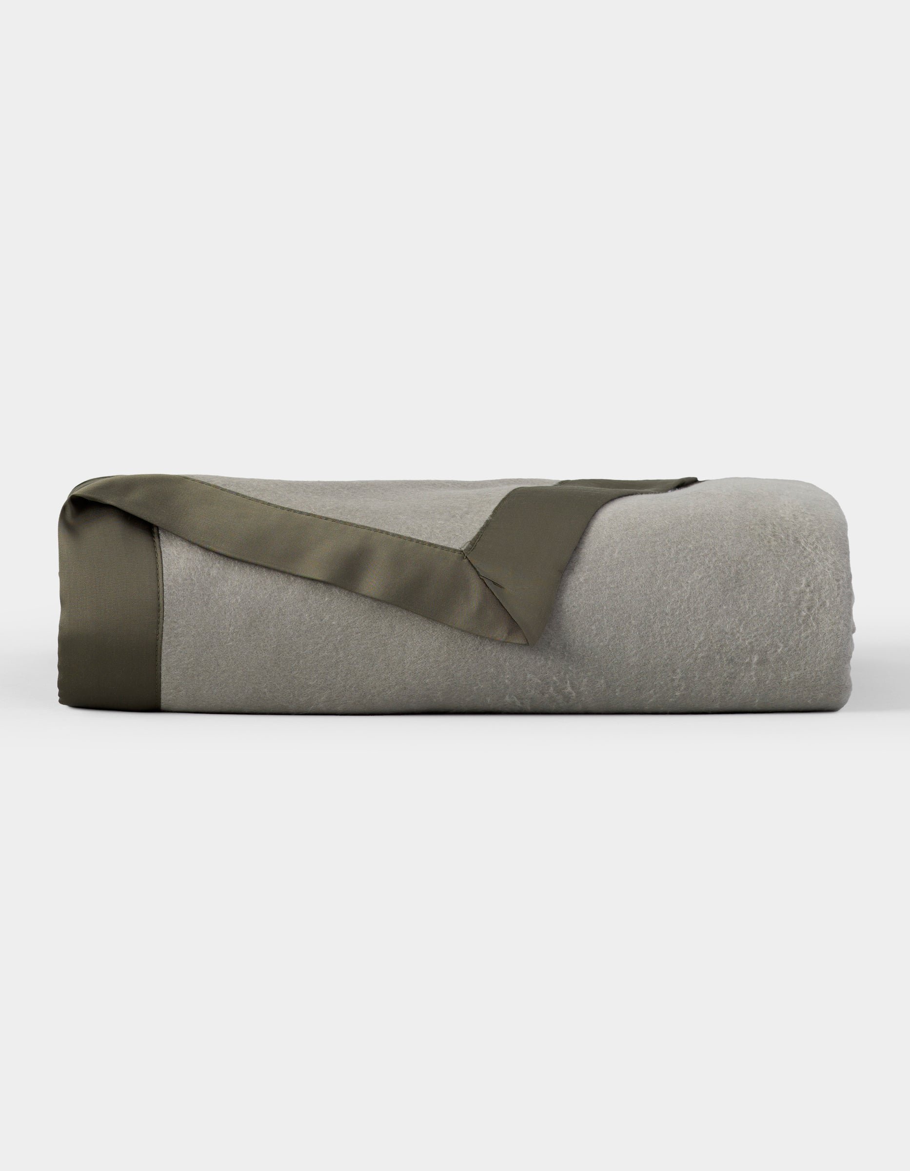 The Cozy Earth Bamboo Blanket, shown neatly folded with an olive green satin trim, is featured against a plain white background. |Color:Sage/Olive