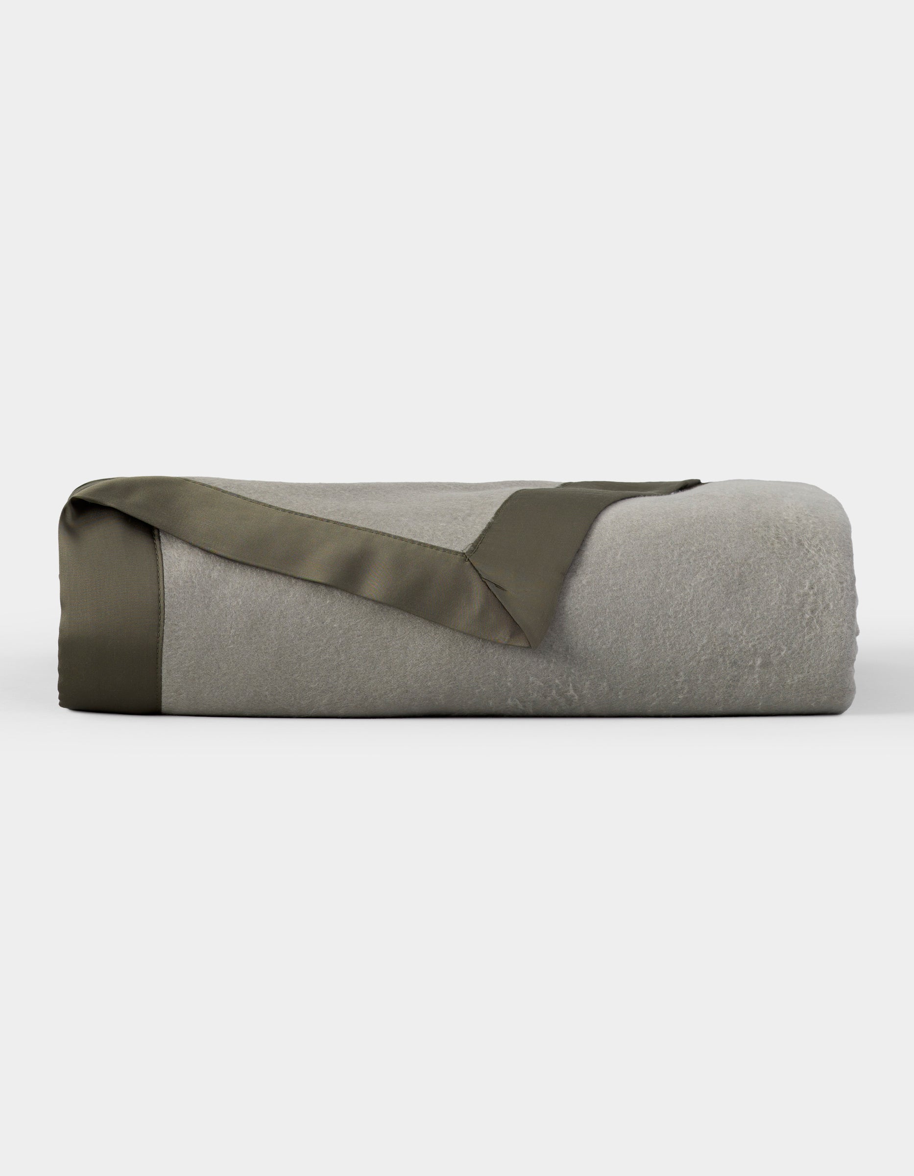 The Cozy Earth Bamboo Blanket, shown neatly folded with an olive green satin trim, is featured against a plain white background. |Color:Sage/Olive