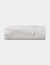 The Cozy Earth Bamboo Baby Blanket, neatly folded with a smooth satin border, is displayed on a plain light background.