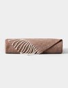 The Cozy Earth Bamboo Herringbone Tassel Throw, in light brown with a subtle herringbone pattern and white fringe, is shown folded on a plain gray background.|Color:Truffle