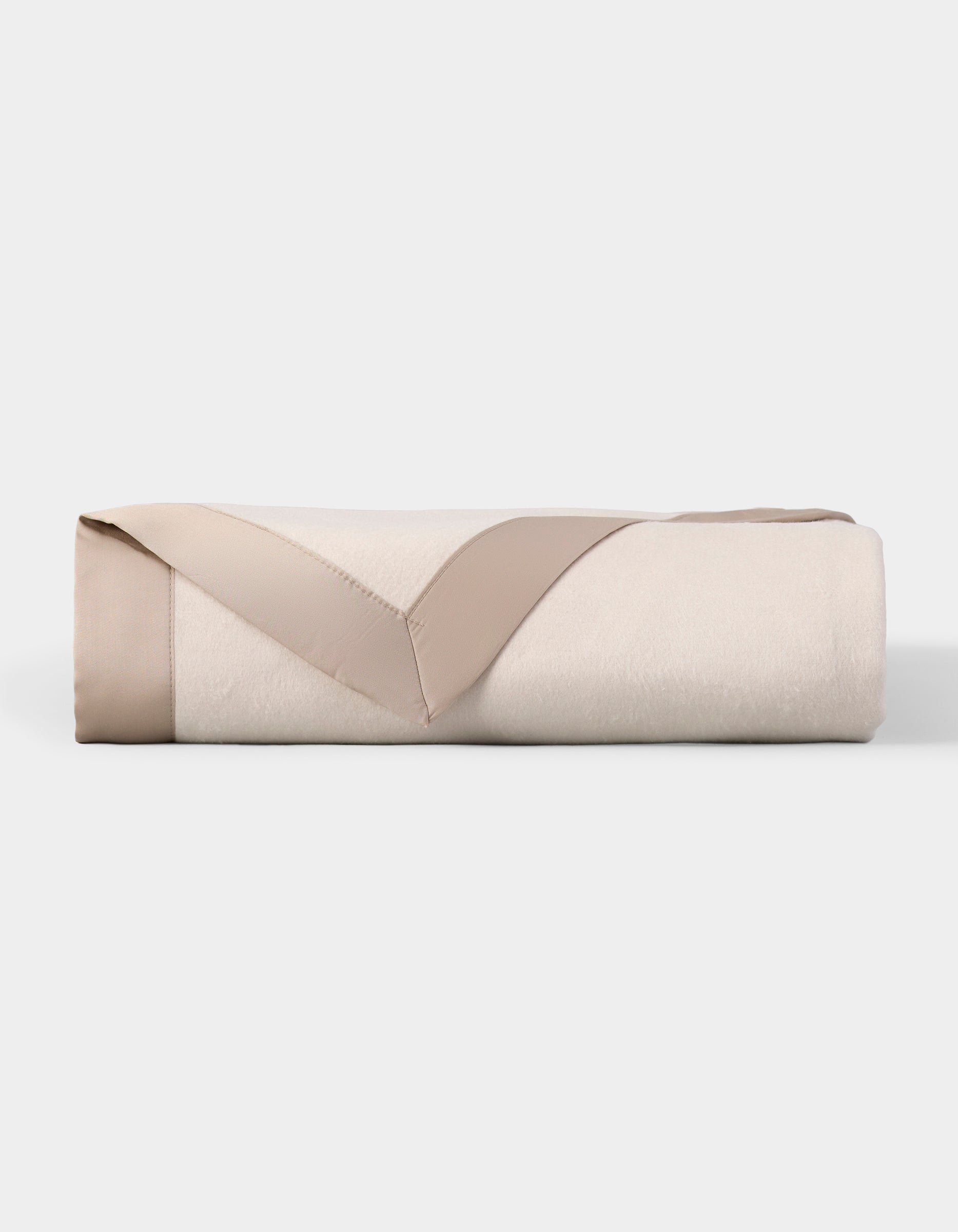 The Cozy Earth Bamboo Blanket is neatly folded, cream-colored with a beige satin trim, and displayed on a plain white background. |Color:Oat/Driftwood