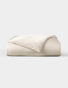 The Cozy Earth Bamboo Duvet Cover, shown neatly folded with one corner flipped to reveal its soft, smooth fabric, is displayed against a plain light gray background.|Color:Oat